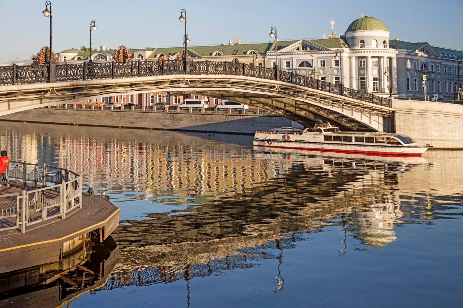 Russian scene: River trips on the Moscow river, view for the Vodootvodny canal in Moscow near Bolotnaya square at dusk by elenarostunova