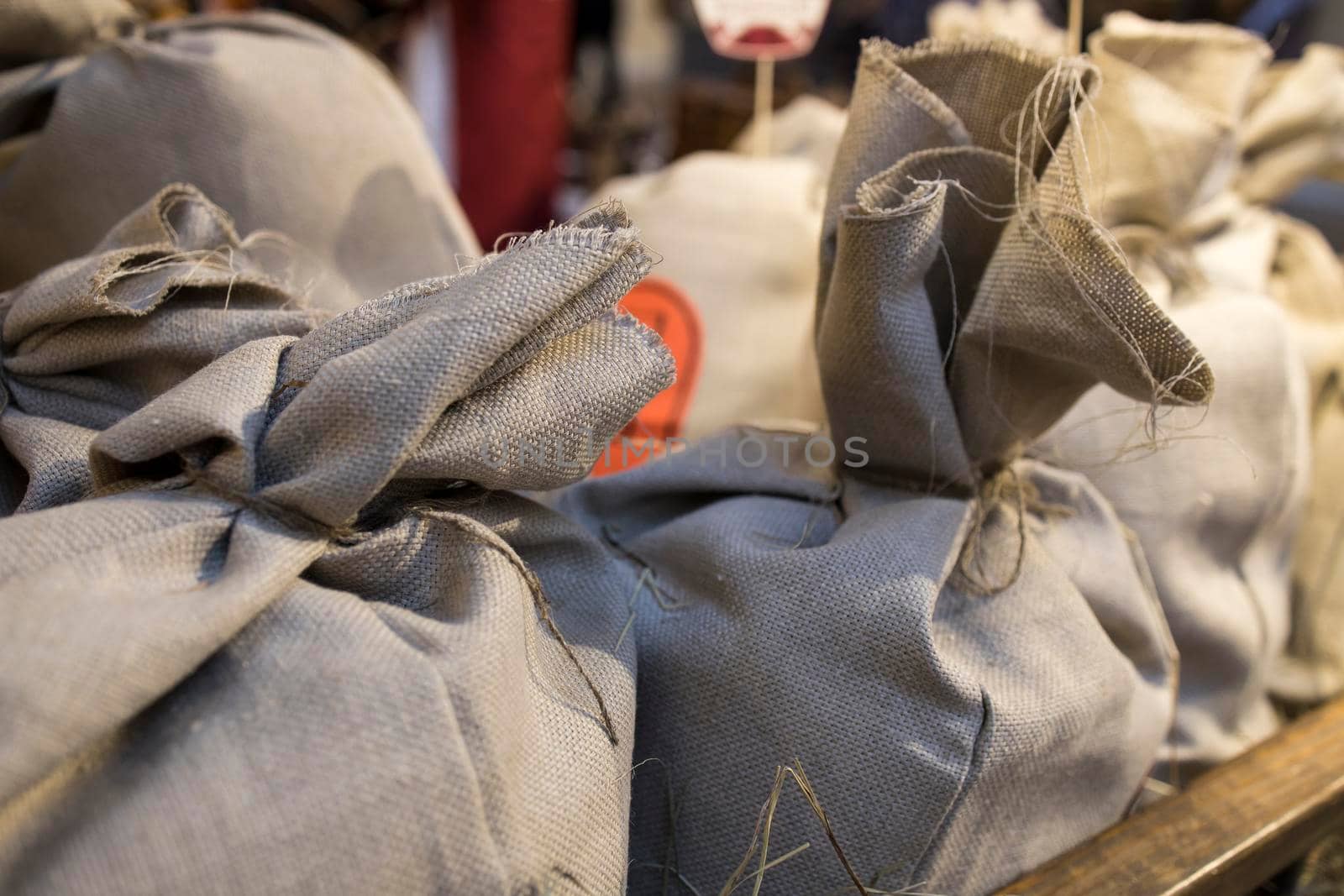 Canvas bags of grain on a trolley as decoration at the farmers' market by elenarostunova