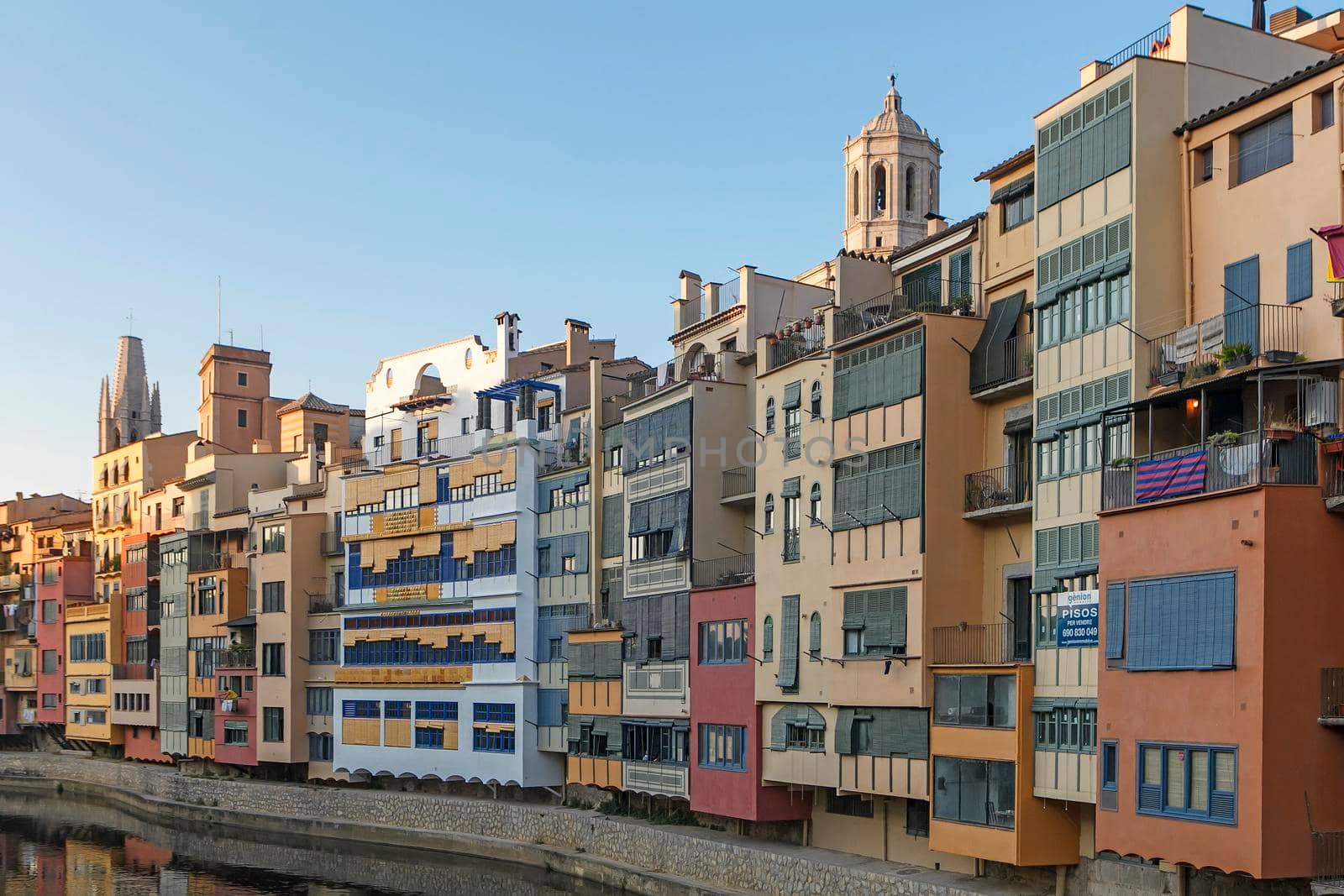 GIRONA, CATALONIA , SPAIN - JUNE 15, 2019: historical jewish quarter in Girona with Eiffel Bridge at sunrise, Barcelona, Spain, Catalonia