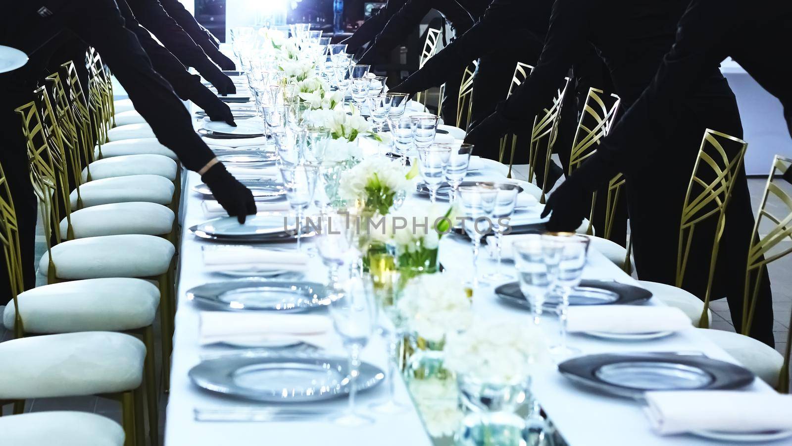 Large group of waiters serving a banquet
