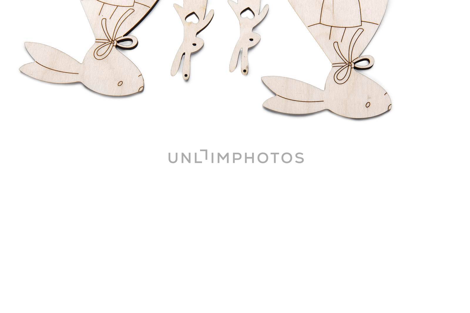 Frame for text. Wooden plywood figures of hares of different sizes, s on a white background