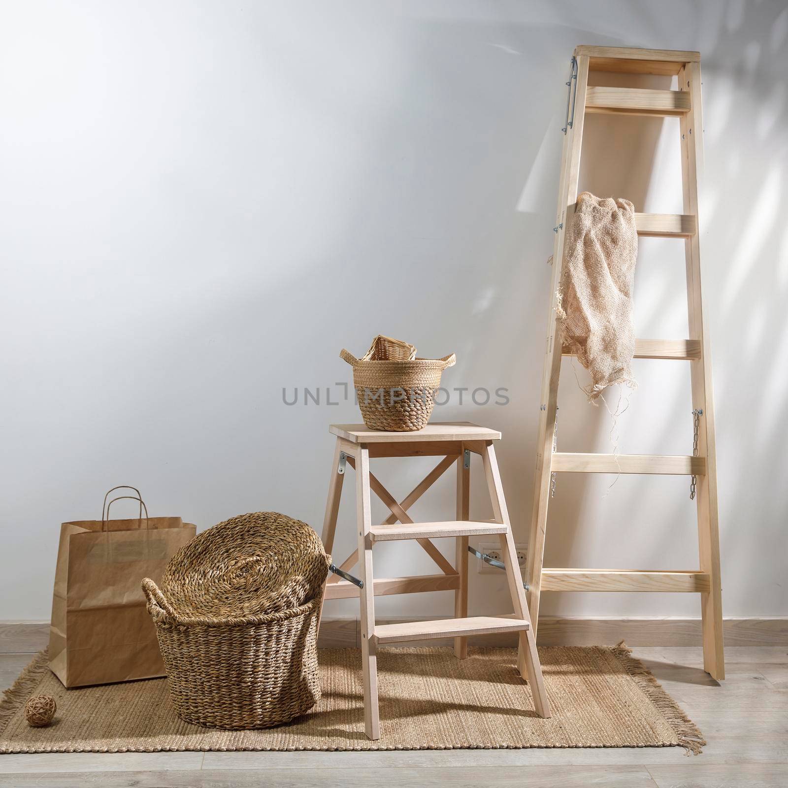 Storage room. Wooden stairs, wicker baskets on a mat. Copy space. Place for text. Copy space