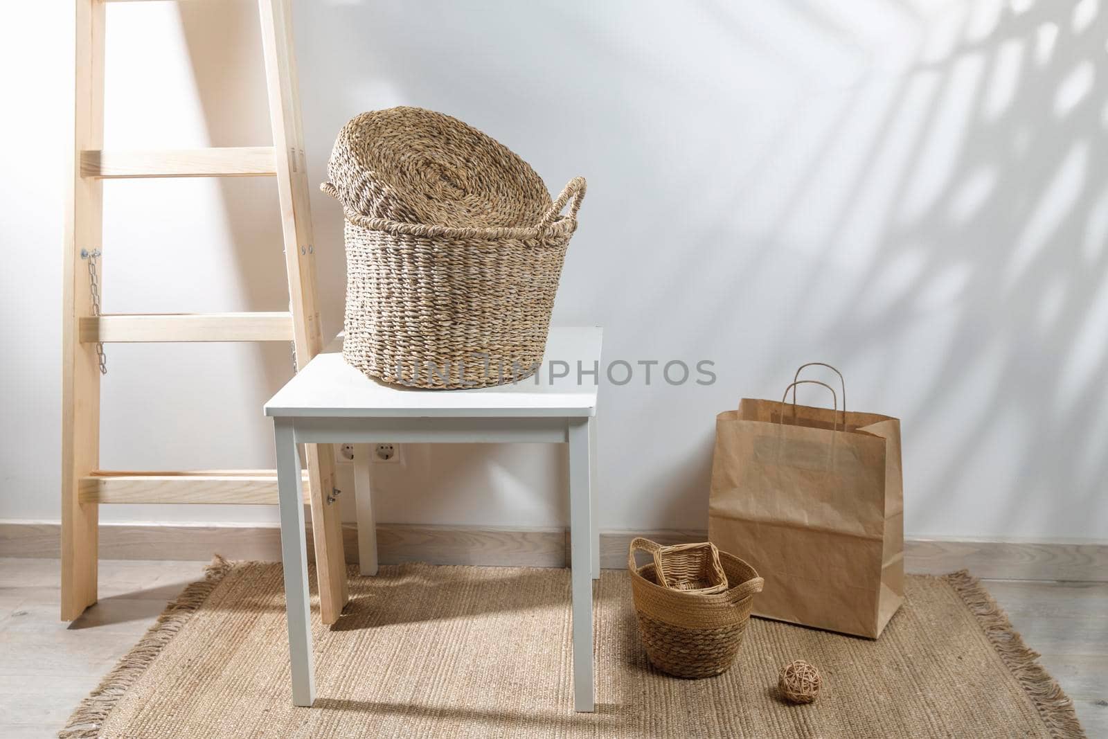 Storage room. Wooden stairs, wicker baskets on a mat. Copy space. Place for text. Copy space by elenarostunova