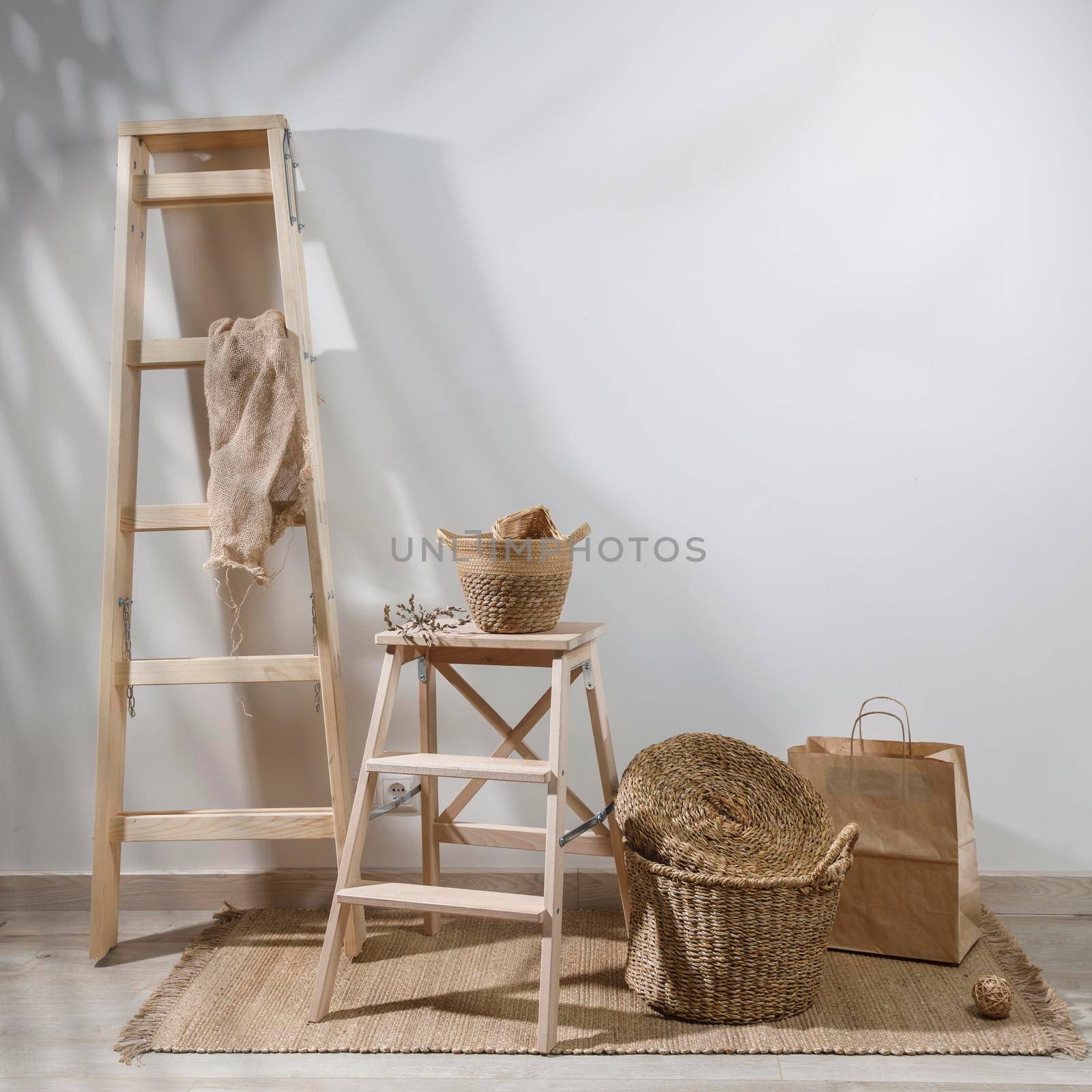 Storage room. Wooden stairs, wicker baskets on a mat. Copy space. Place for text. Copy space by elenarostunova