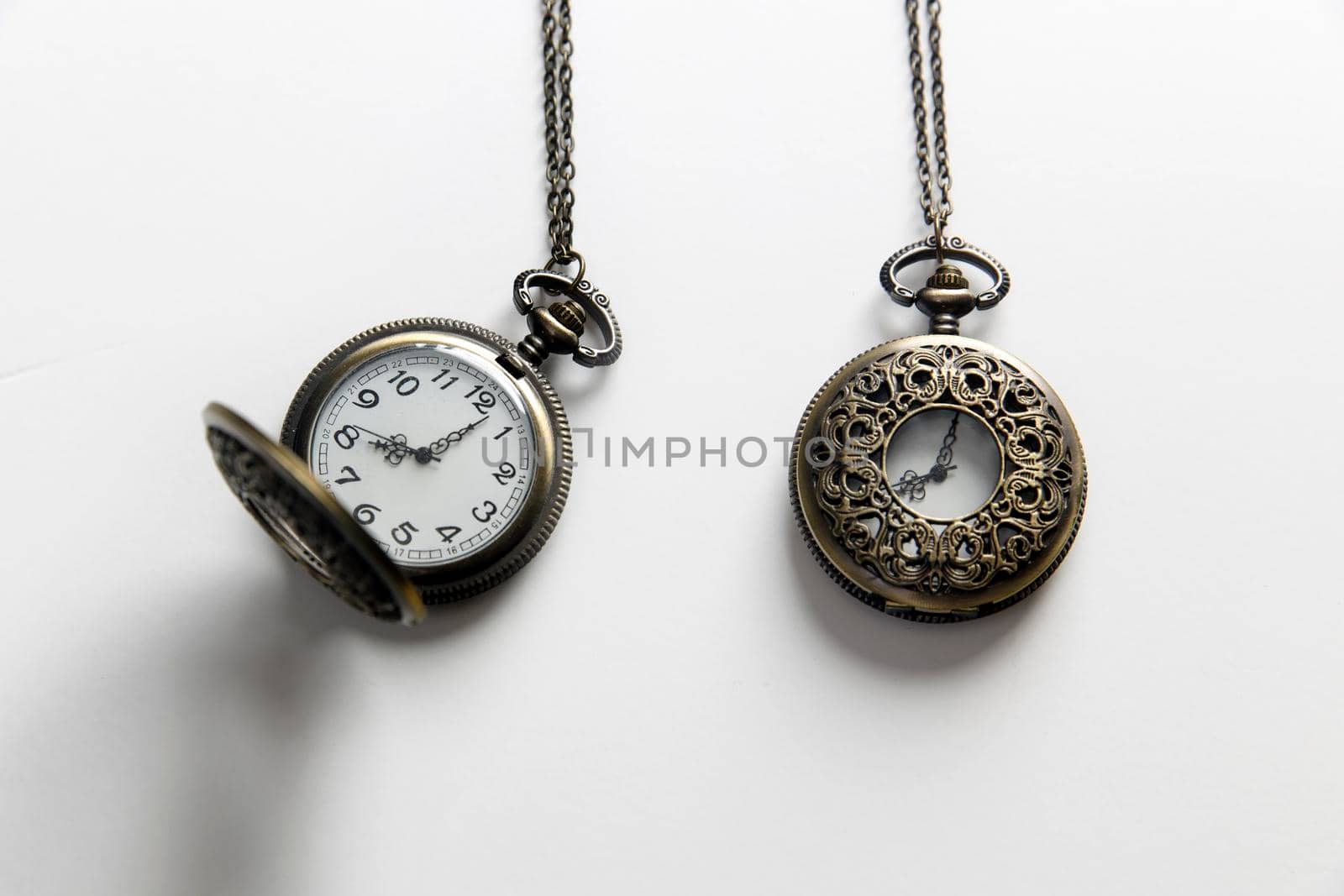 Pocket watch with chain closed and open on white background by elenarostunova