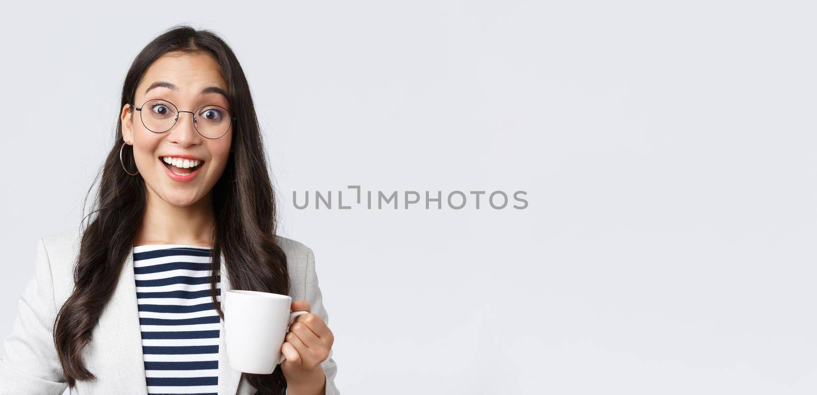Business, finance and employment, female successful entrepreneurs concept. Close-up of outgoing smiling asian office worker talking to coworker at office kitchen, drinking coffee.