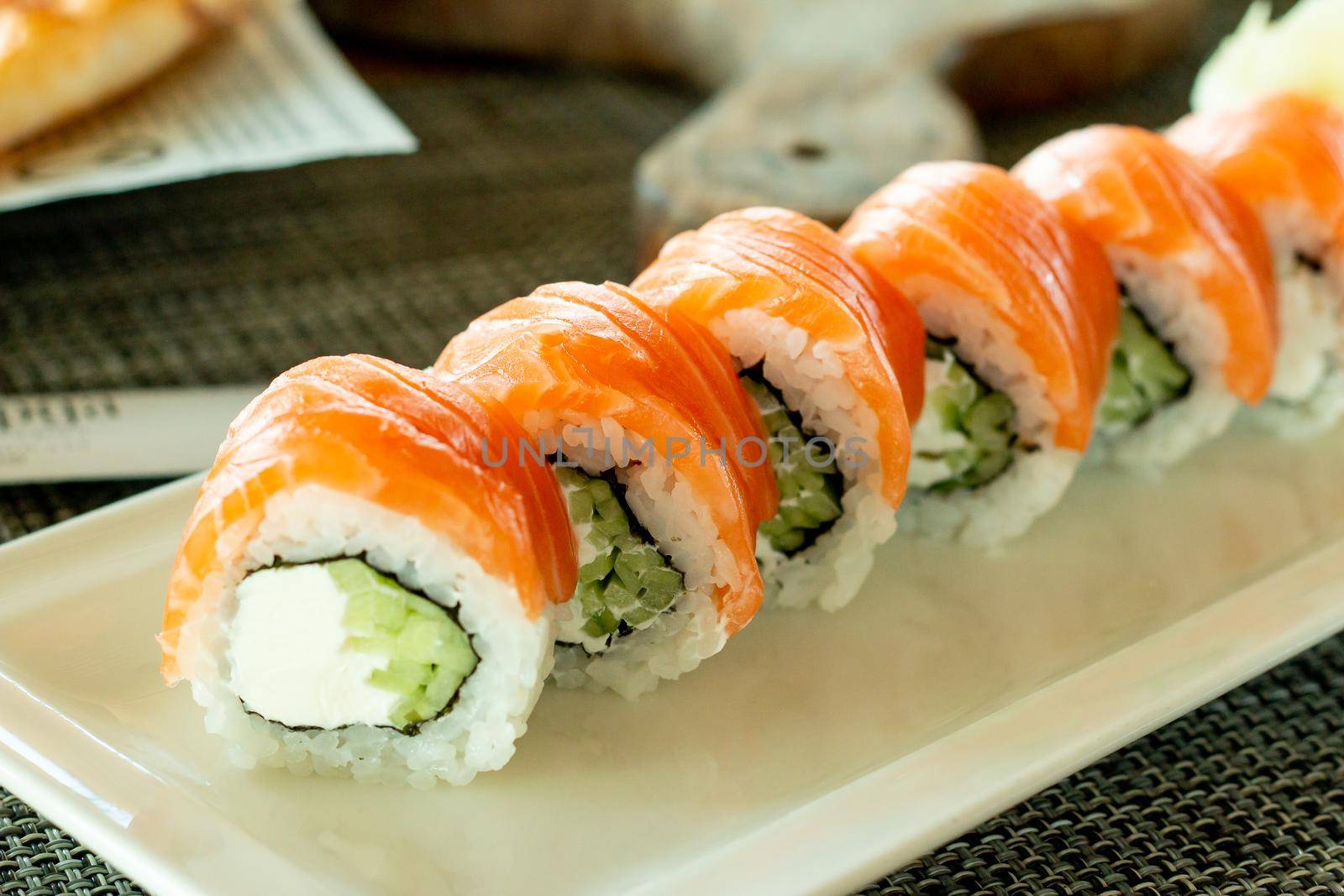 Philadelphia roll sushi with salmon, prawn, avocado, cream cheese. Sushi menu. Japanese food.