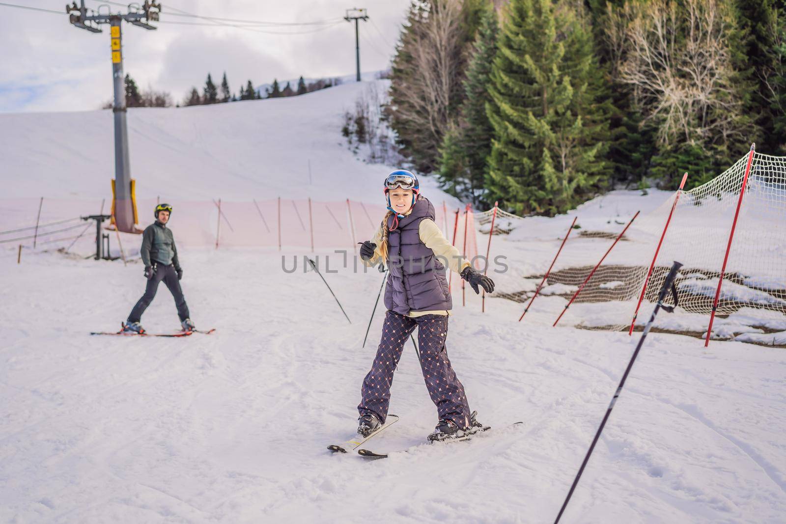 Woman learning to ski with instructor. Winter sport. Ski lesson in alpine school.