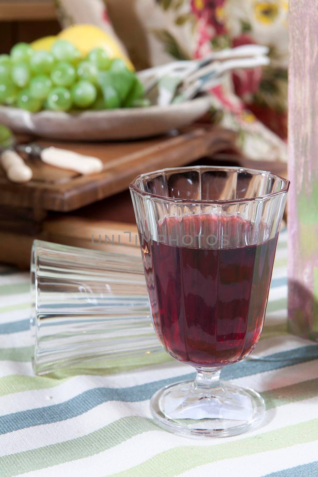 glass of red wine on the fascia table-cloth by elenarostunova