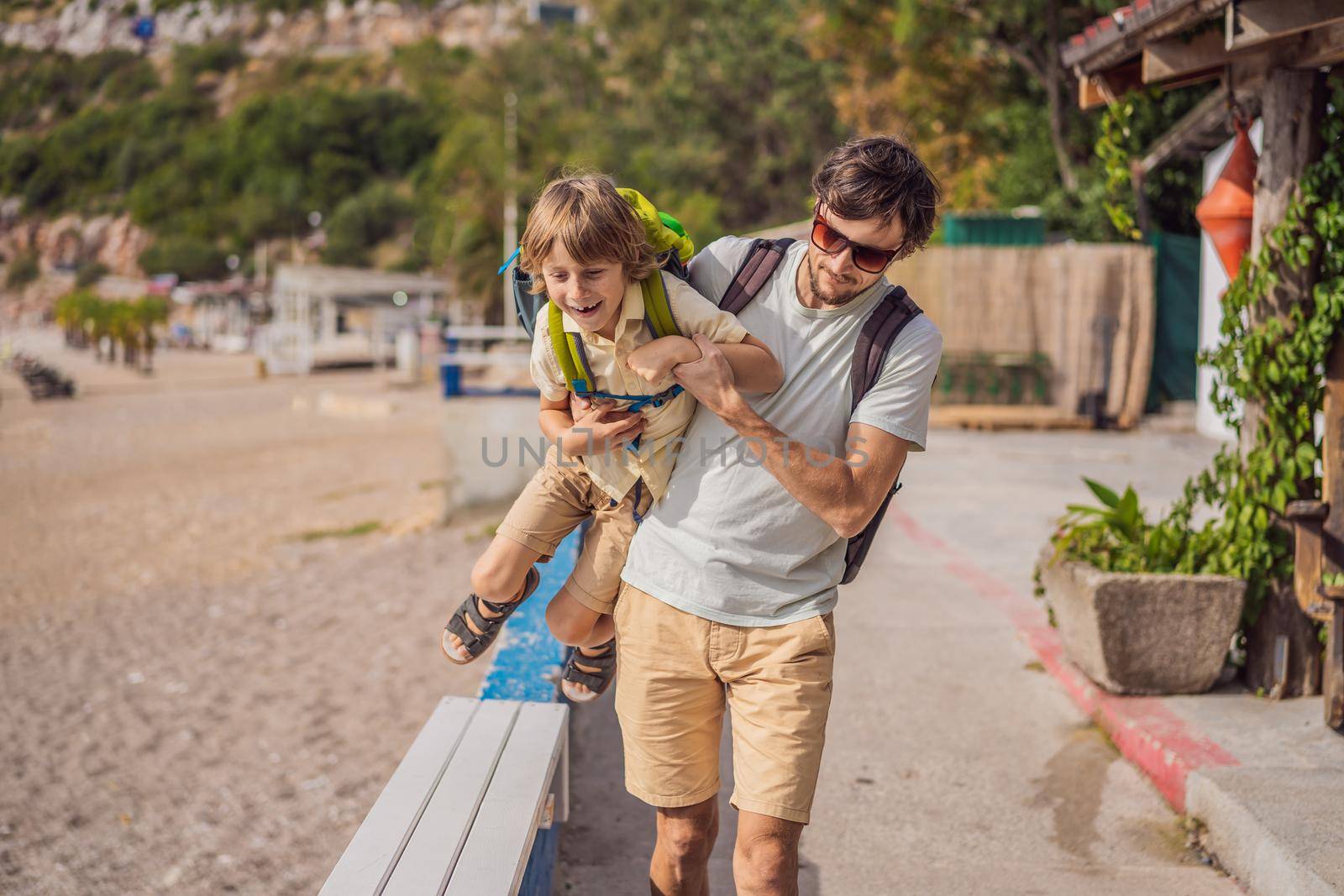 Dad and son tourists walks along the coast of Budva in Montenegro.