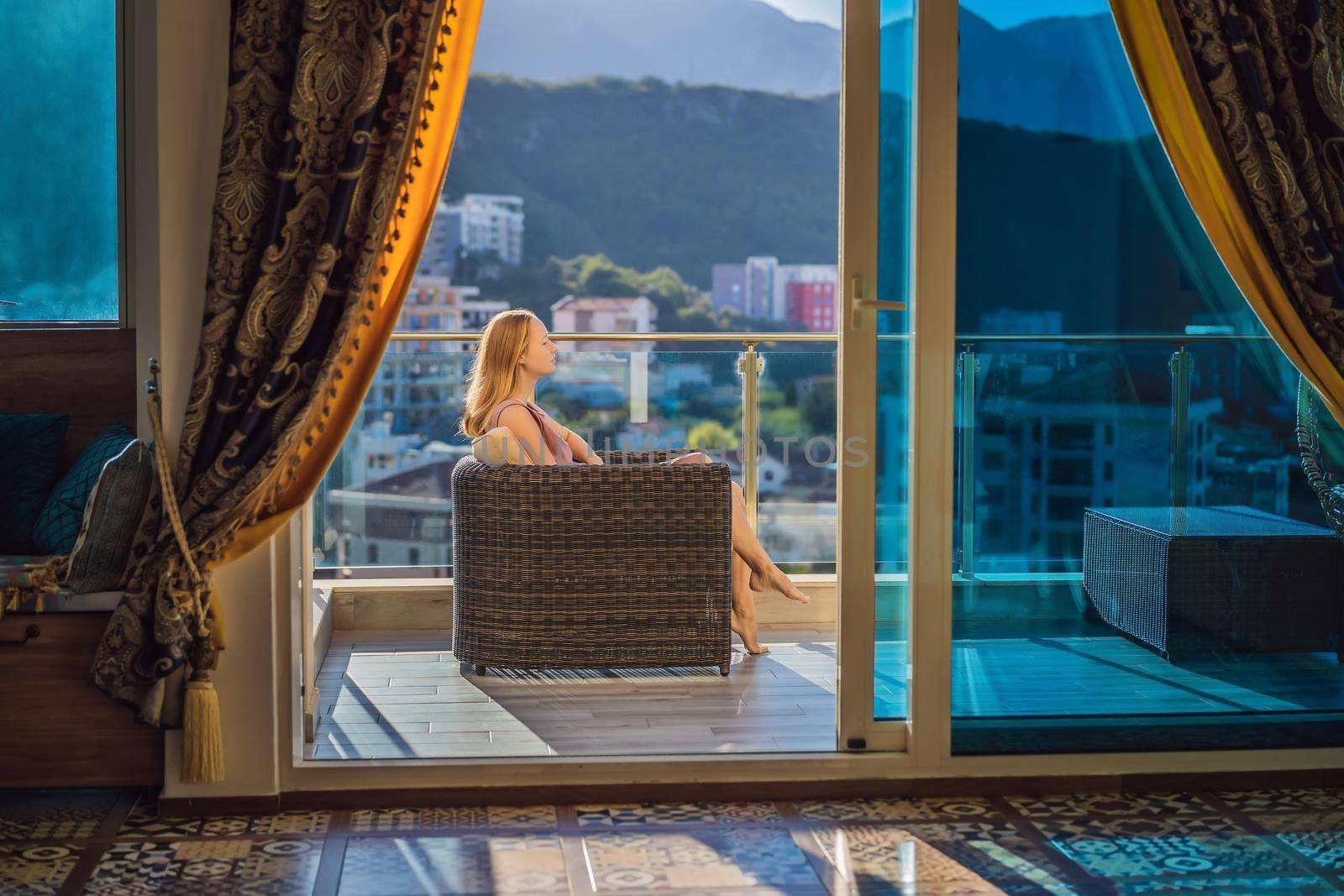 Woman on the balcony against the backdrop of mountains and city, Montenegro. life terrace pretty happiness summer home. Inspiration city romantic hotel by galitskaya