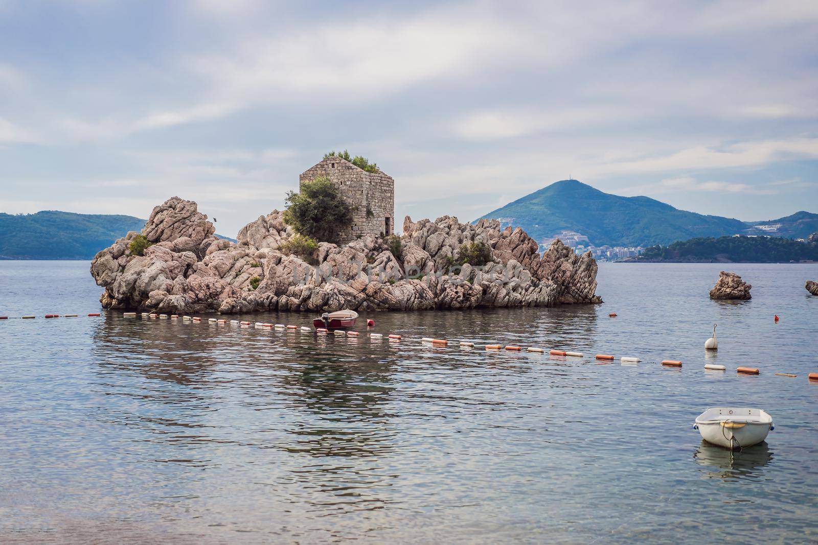 Picturesque summer view of Adriatic sea coast in Budva Riviera near Przno village. Cozy beach and buildings on the rock. Location: Przno village, Montenegro, Balkans, Europe.