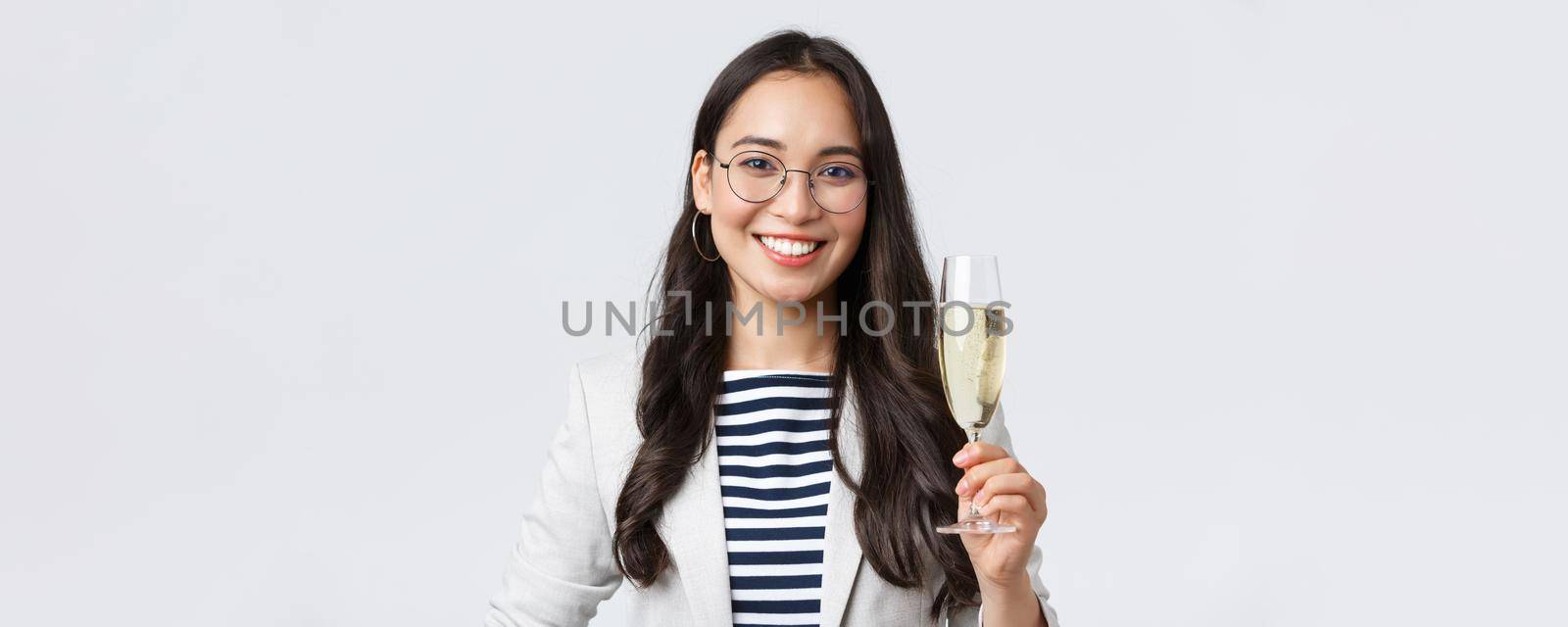 Business, finance and employment, female successful entrepreneurs concept. Happy asian businesswoman celebrating signing of contract, having office party, drinking champagne.