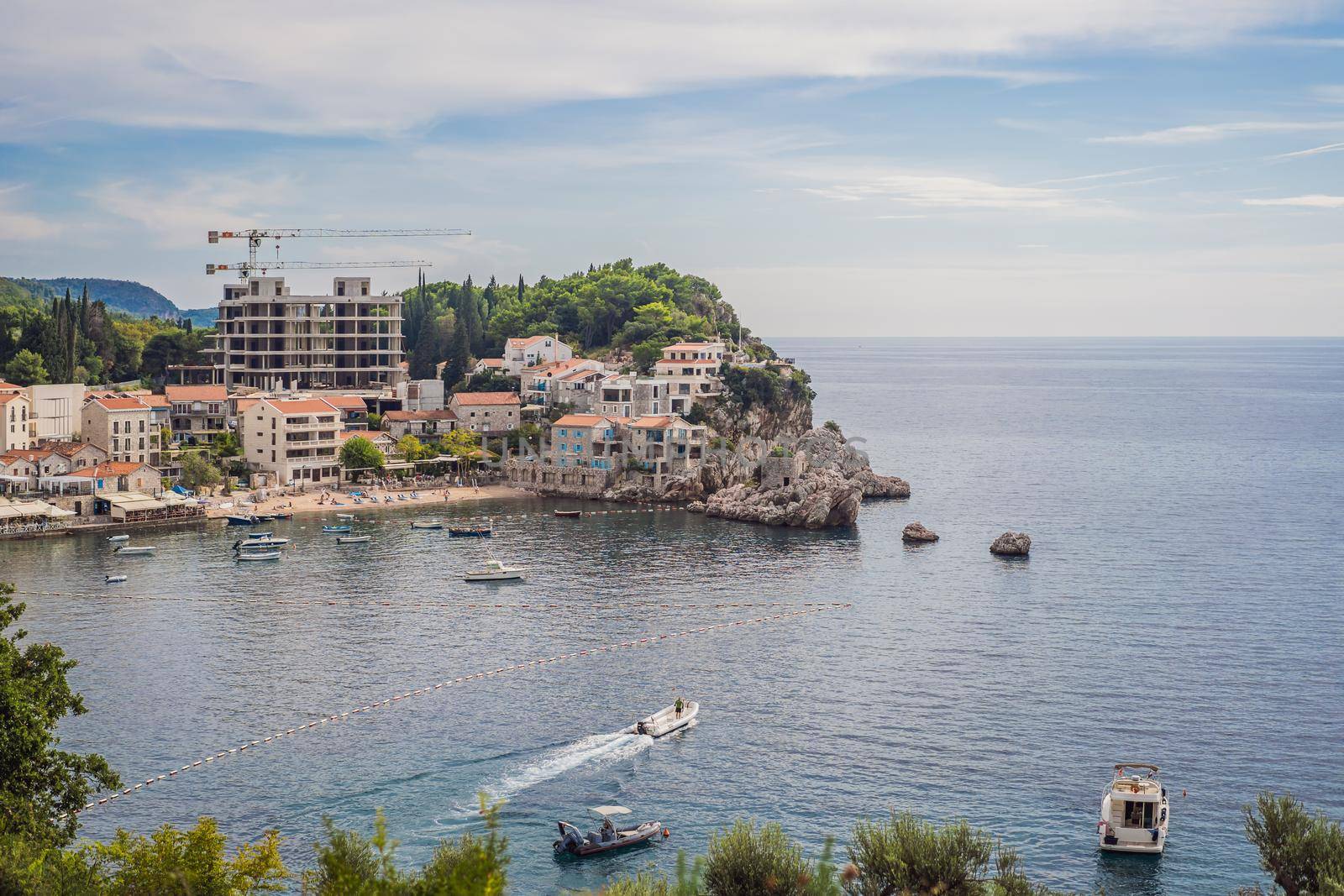 Picturesque summer view of Adriatic sea coast in Budva Riviera near Przno village. Cozy beach and buildings on the rock. Location: Przno village, Montenegro, Balkans, Europe.