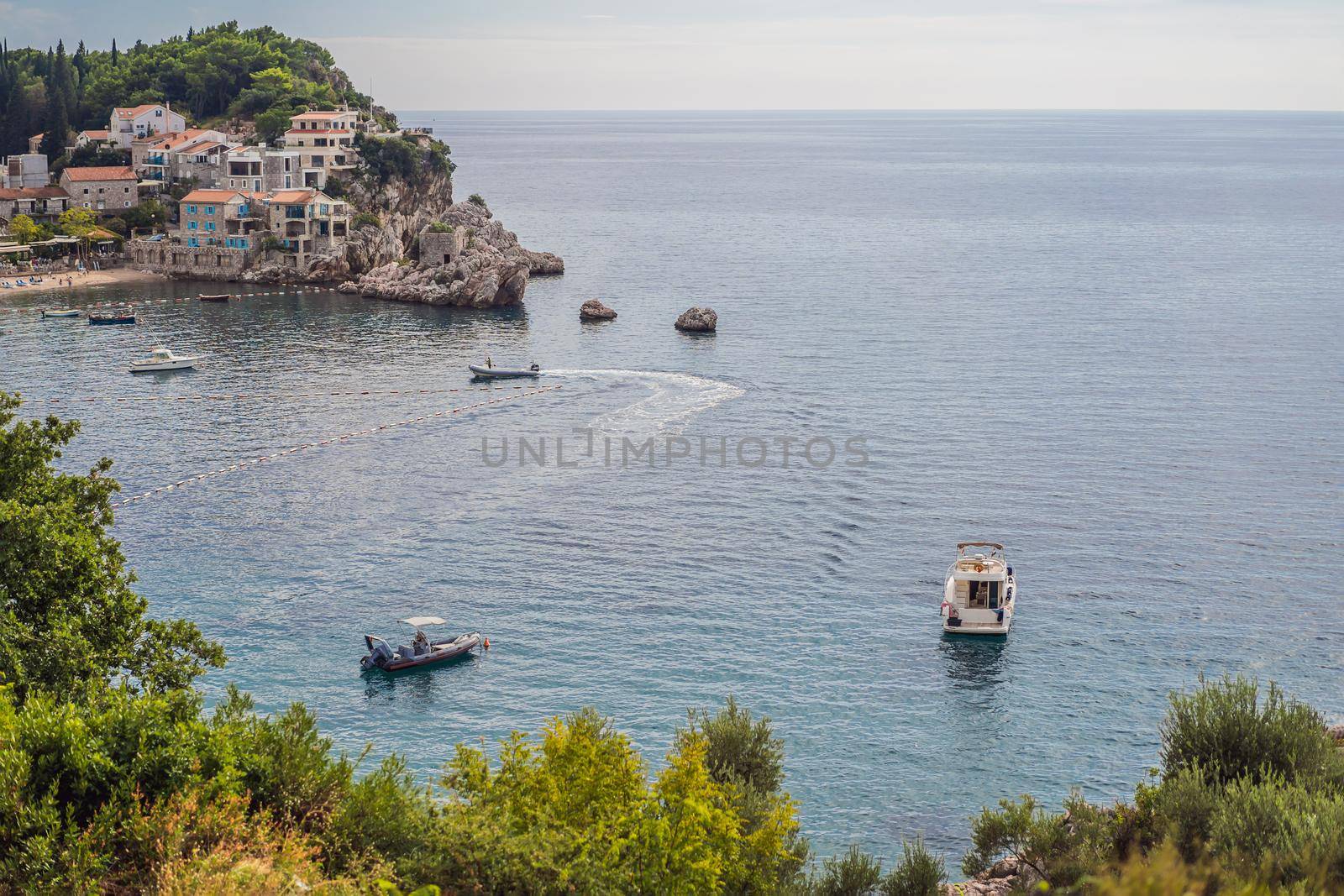 Picturesque summer view of Adriatic sea coast in Budva Riviera near Przno village. Cozy beach and buildings on the rock. Location: Przno village, Montenegro, Balkans, Europe by galitskaya