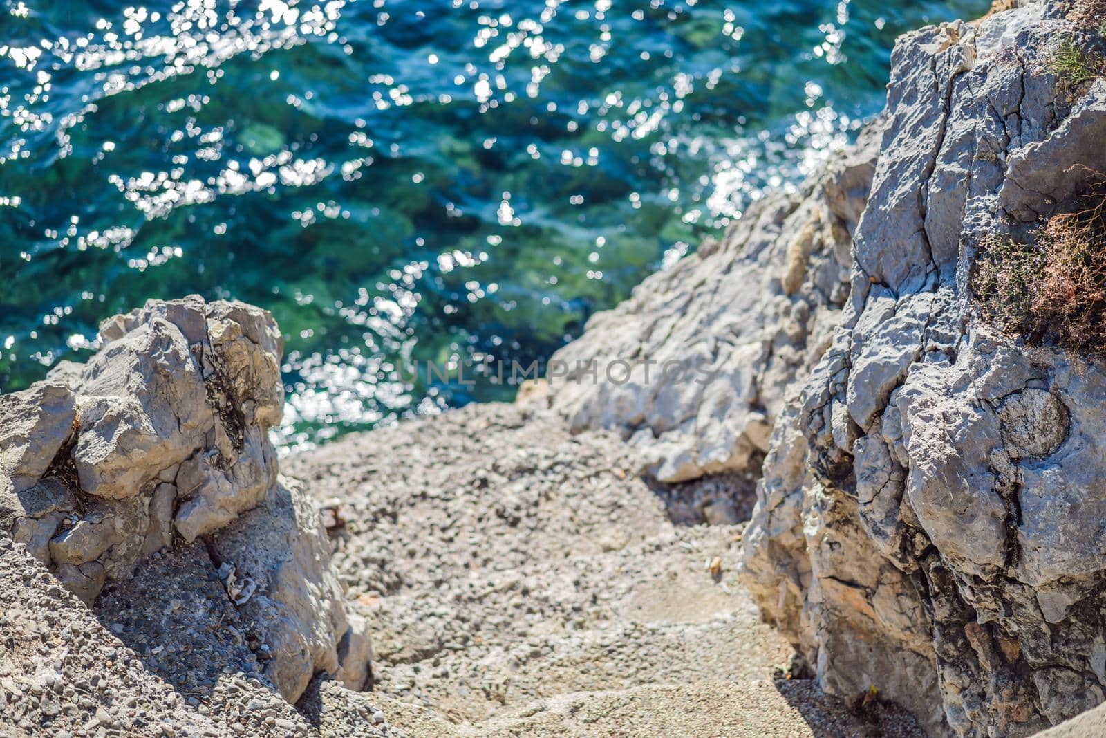 Turquoise sea water of Mediterranean sea. Beautiful emerald green watercolor. Shiny clear ocean water. Transparent bright blue green sea waters surface. Paradise lagoon view.