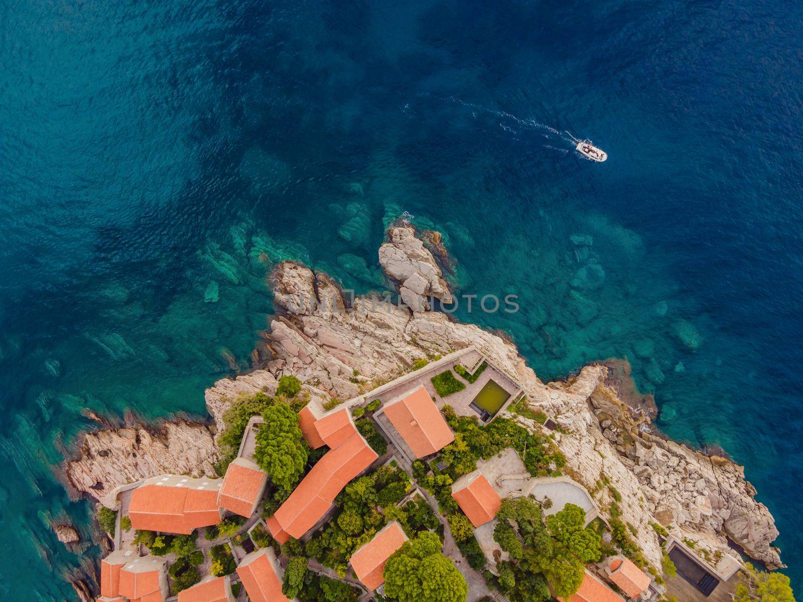 Aerophotography. View from flying drone. Panoramic view of Sveti Stefan island in Budva in a beautiful summer day, Montenegro. Top View. Beautiful destinations.