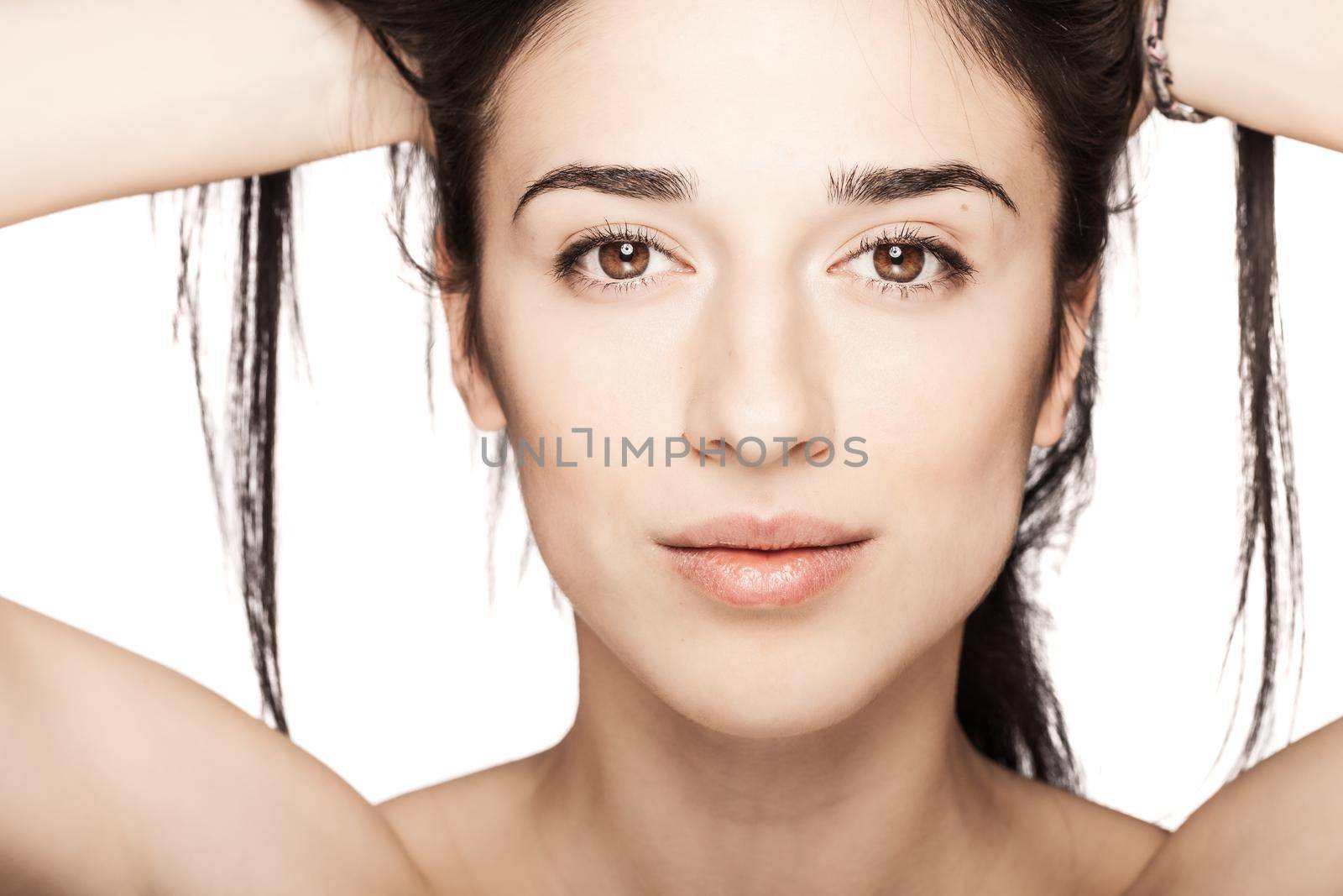 studio portrait of a beautiful young girl against white backgroung. looking at camera.