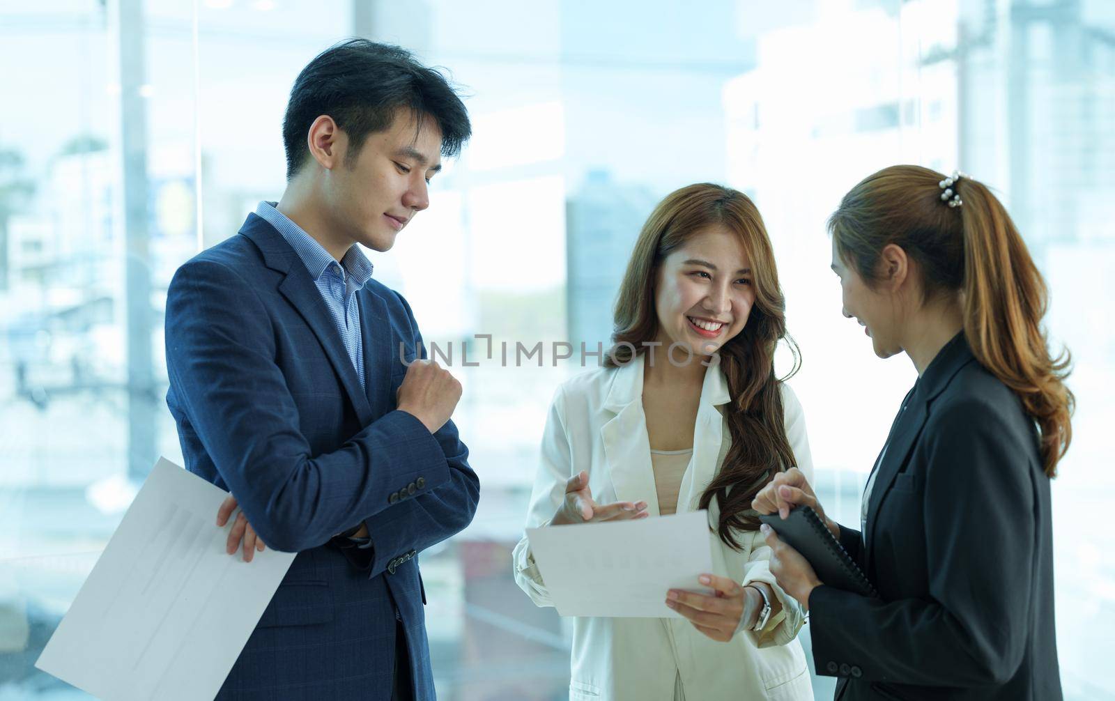 Entrepreneur asian business people discussing new business project in paper sheet in modern meeting room
