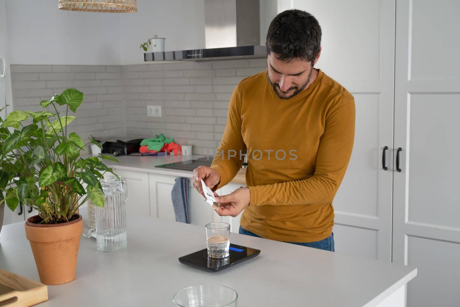 young bearded man making artisan bread in his home kitchen