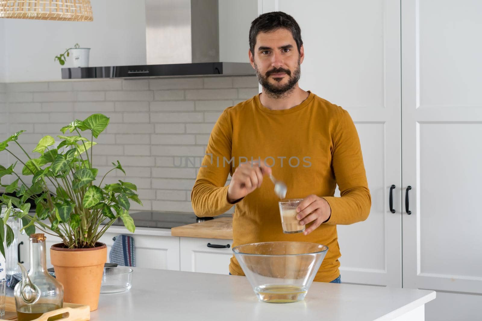 young bearded man making artisan bread in his home kitchen