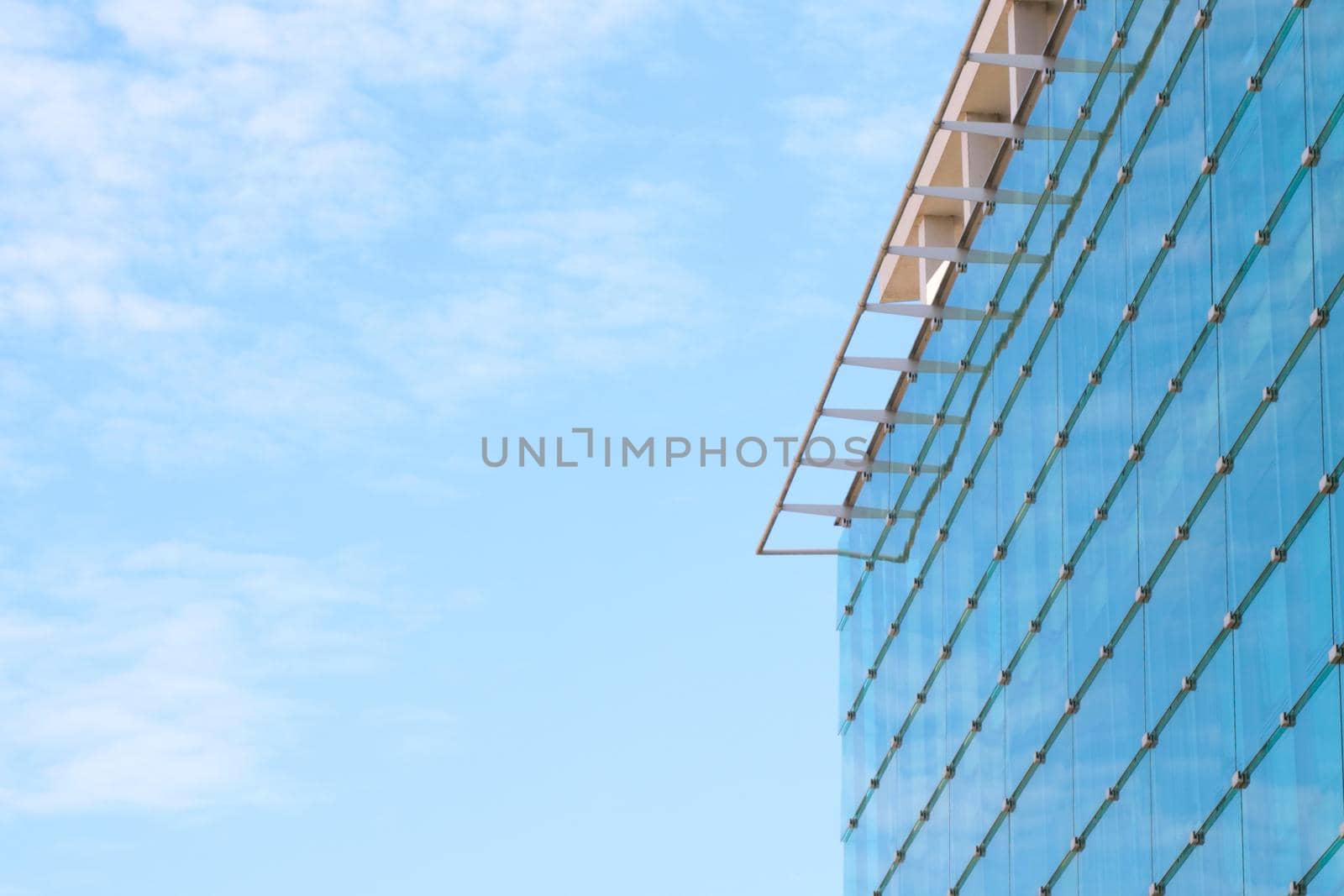 A modern glass building against a blue sky. by kip02kas