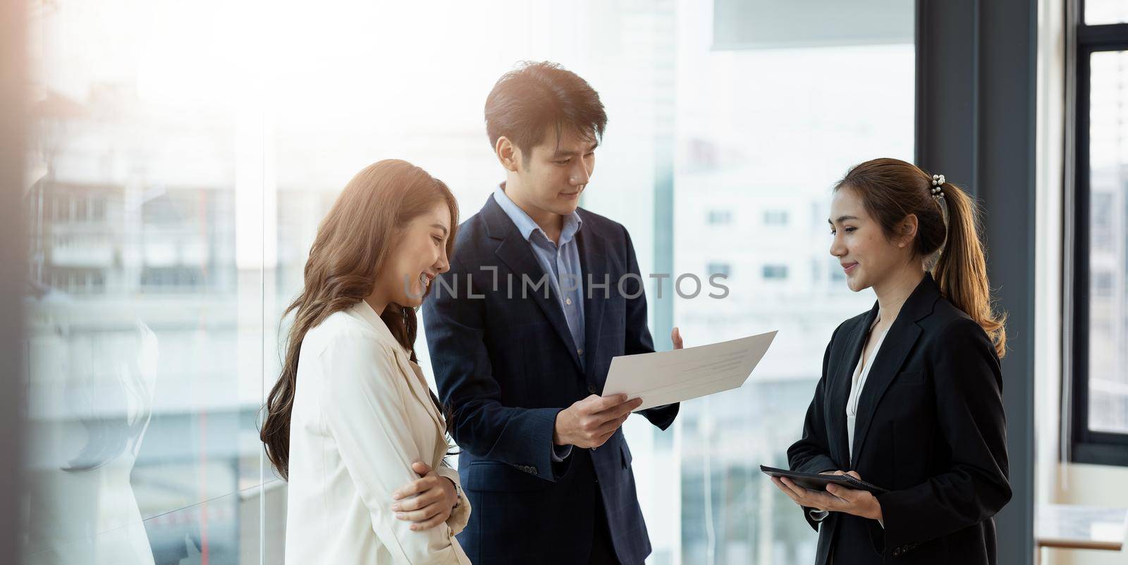 Entrepreneur asian business people discussing new business project in paper sheet in modern meeting room