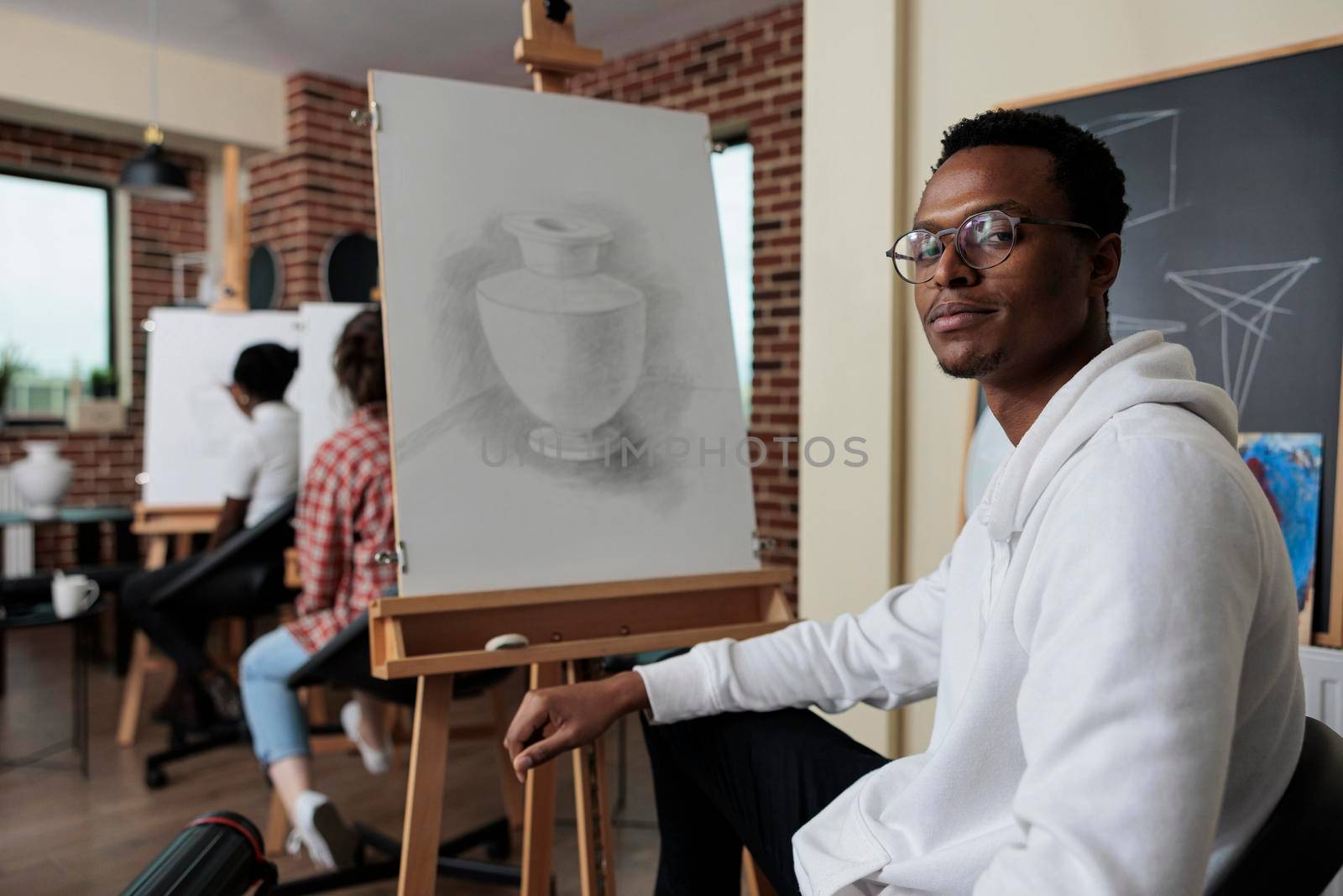 Portrait of smiling african american student attenting art class by DCStudio