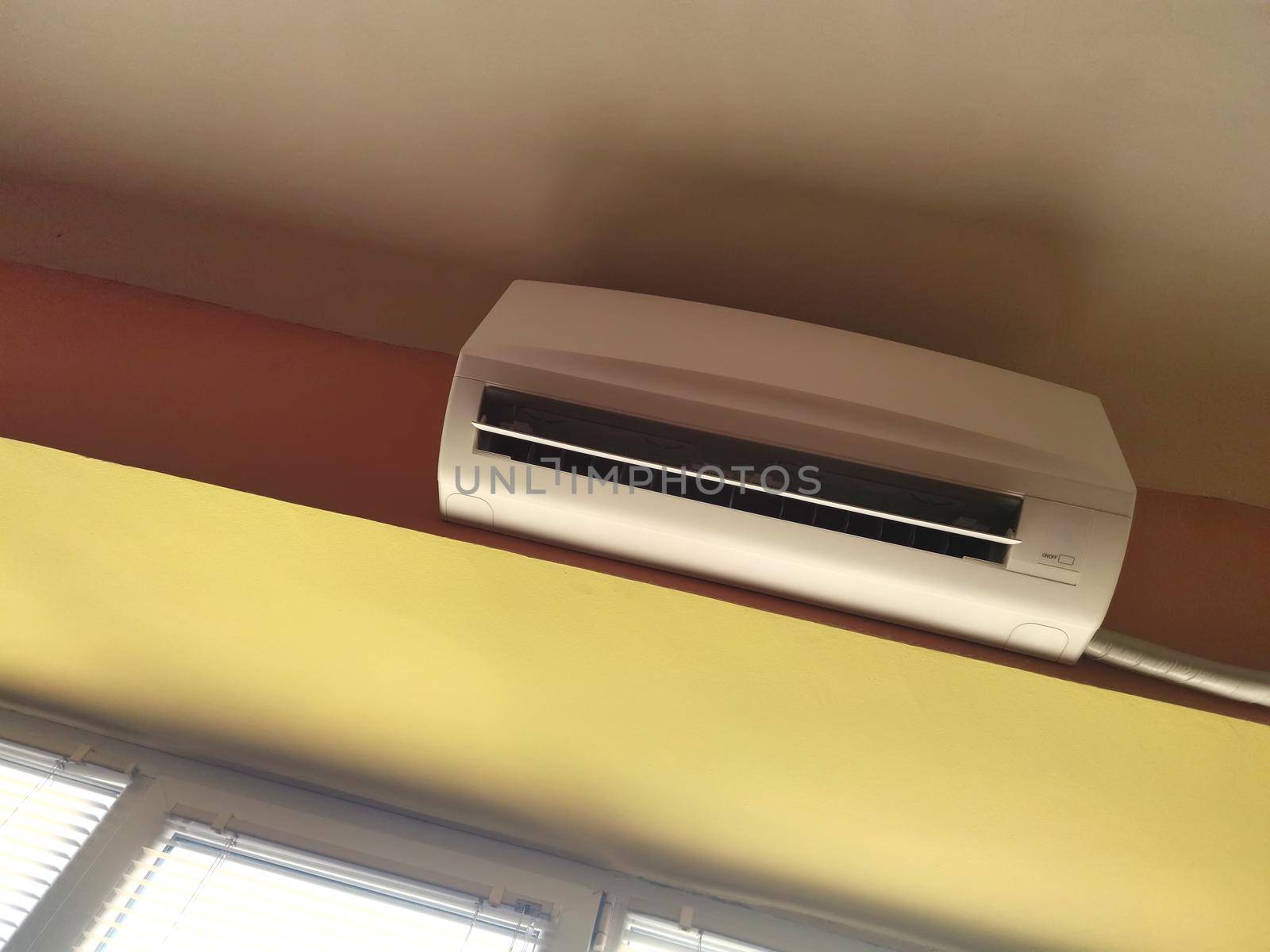 Air conditioner indoor unit mounted on office wall by EdVal