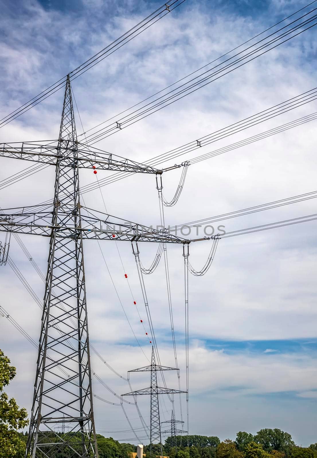 High voltage electric pole and transmission lines. Electricity pylons. Power and energy engineering system. Cable wire on an electric post.  by EdVal