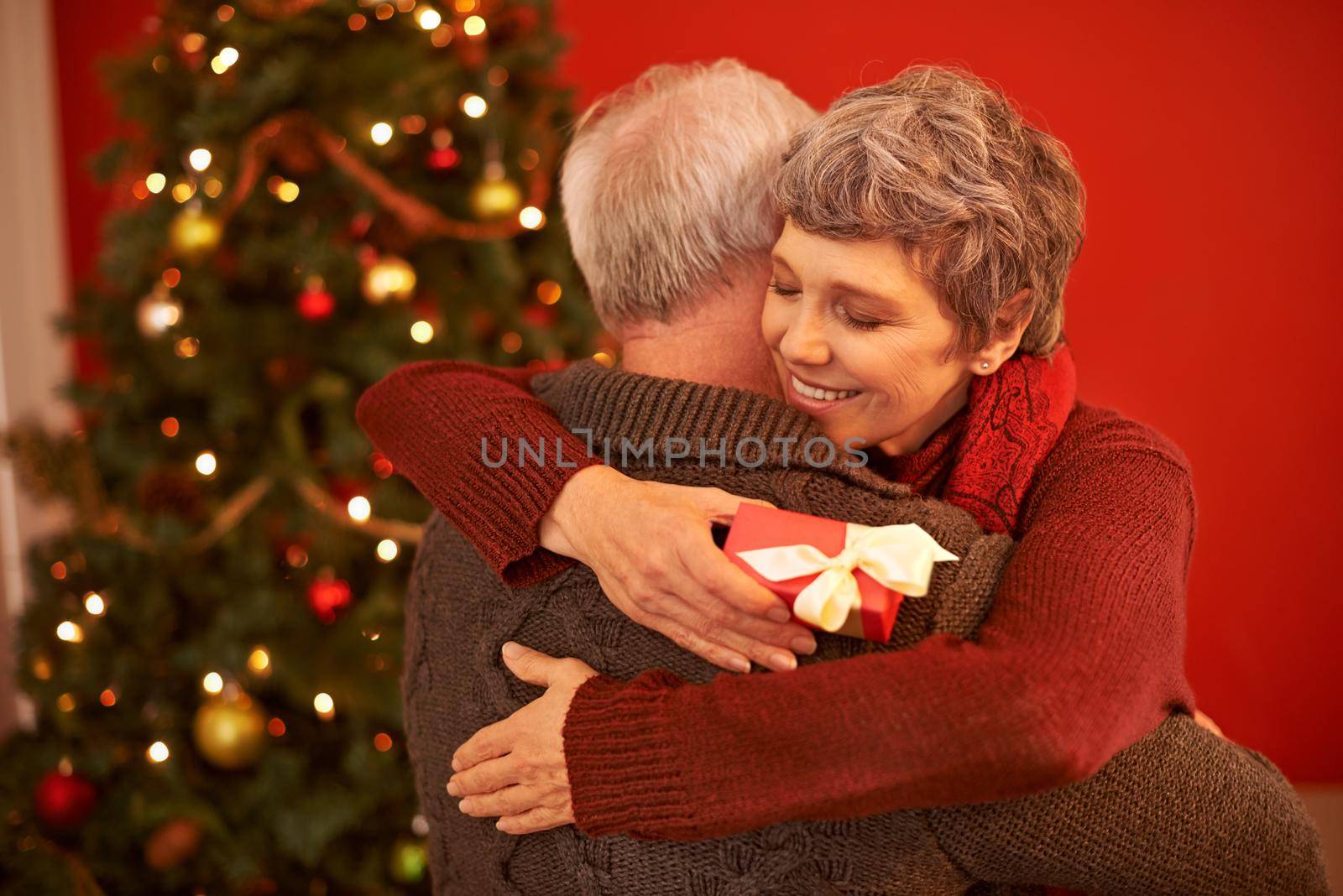 A cropped shot of a loving senior couple exchanging gifts on Christmas.