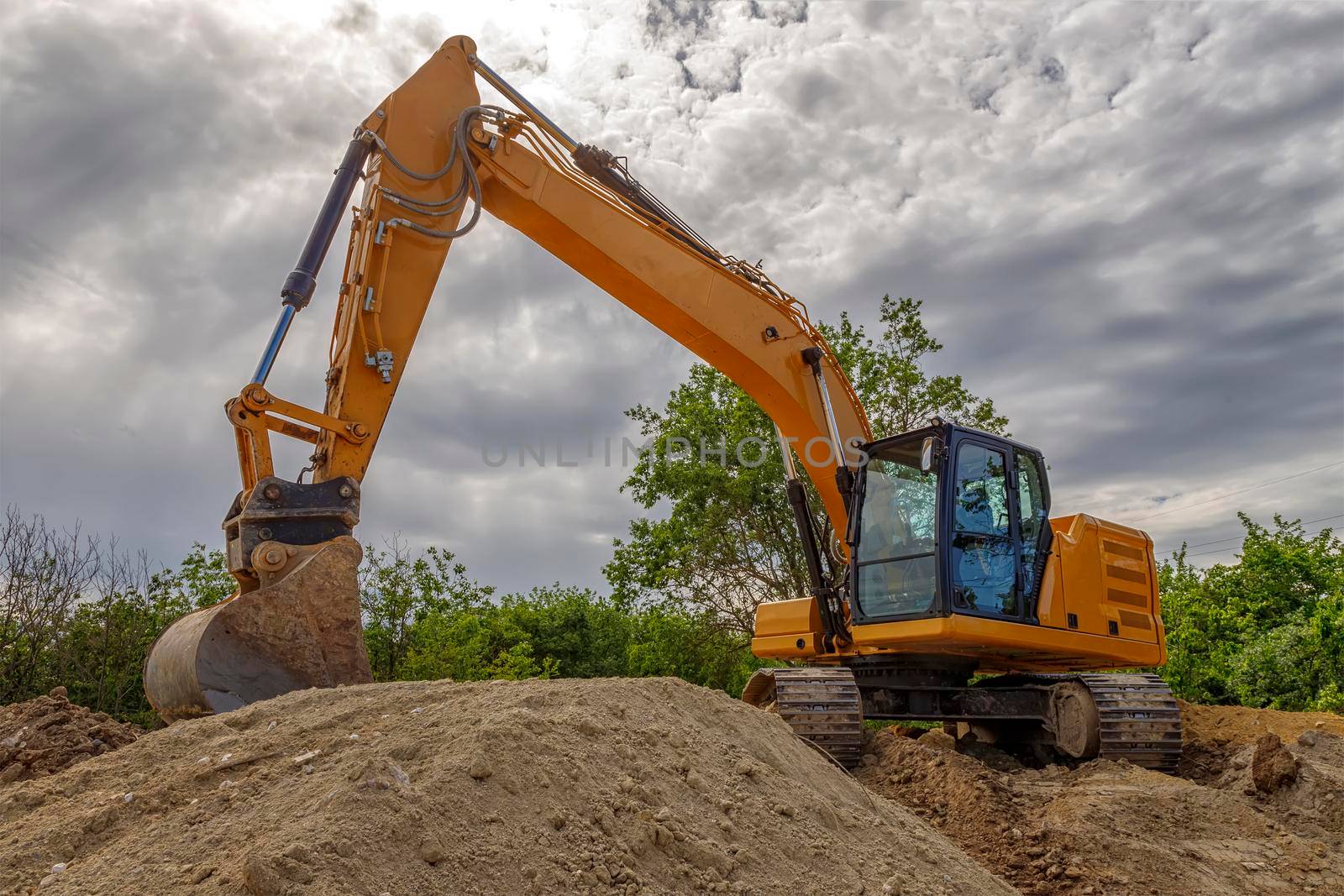 Break, big excavator with a shovel at the construction site. Horizontal view