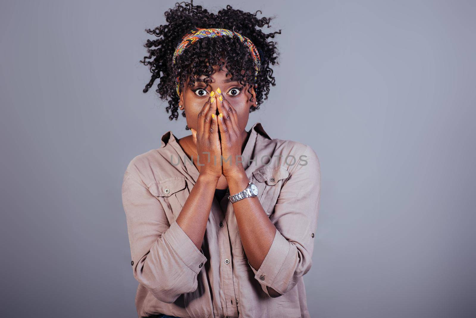 Oh my god gesture. Attractive afro american woman in casual clothes in the studio.