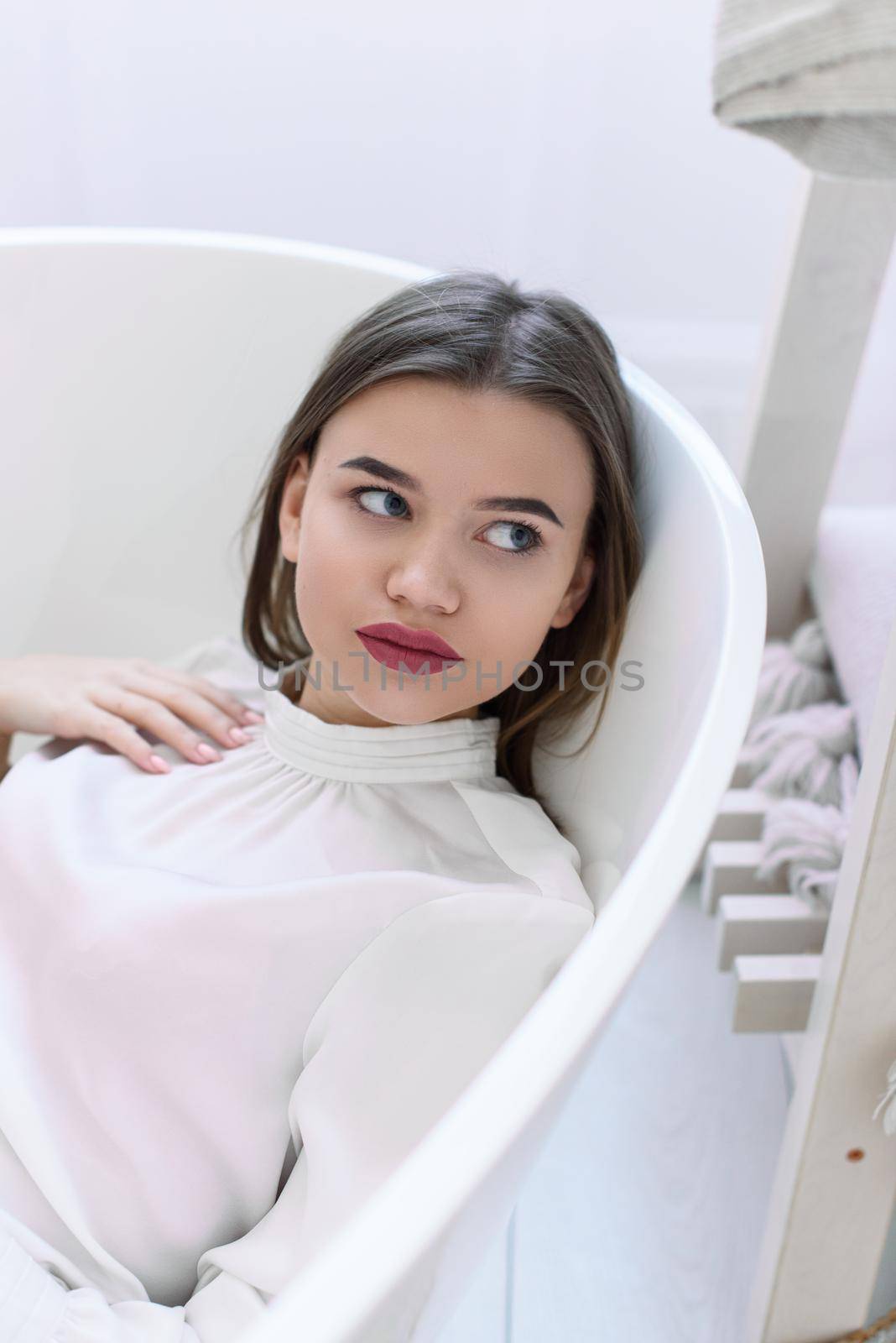 Portrait of fashionable women in a white blouse posing in a bath by Ashtray25