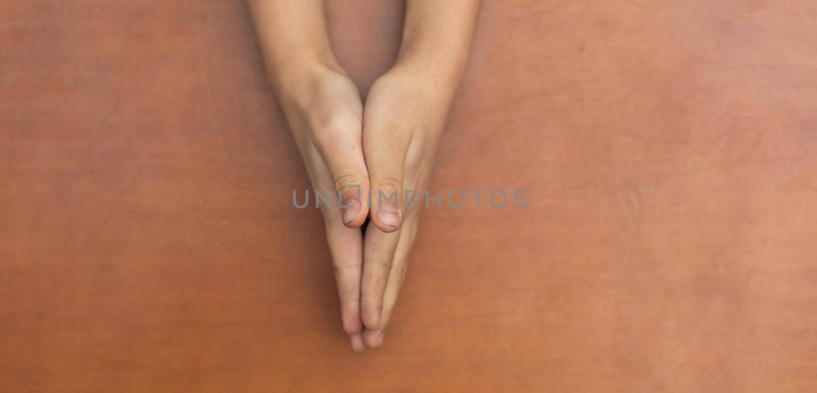 Child's hands folded together in prayer by Andelov13