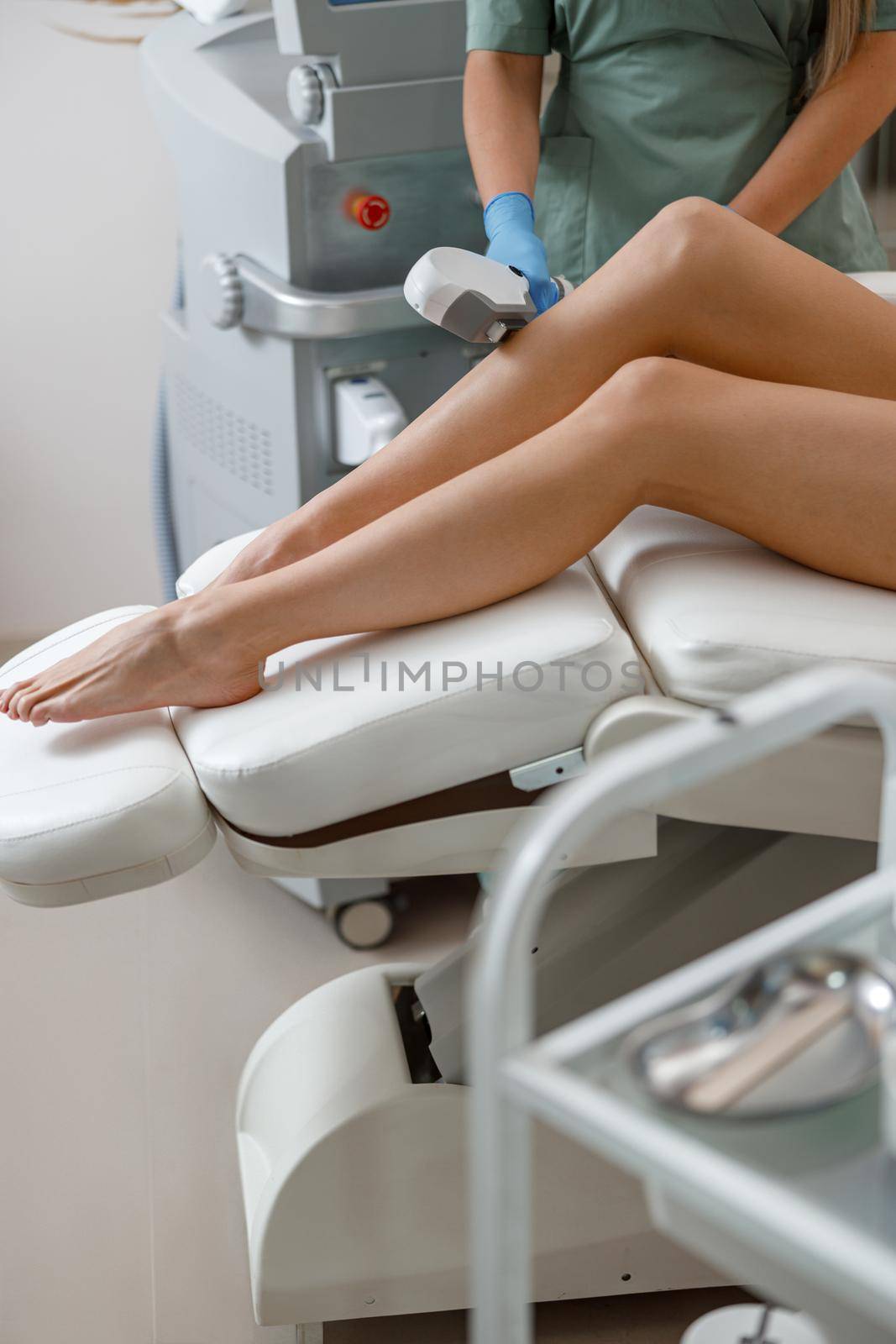 Close up of hair removal procedure on legs in beauty salon by Yaroslav_astakhov