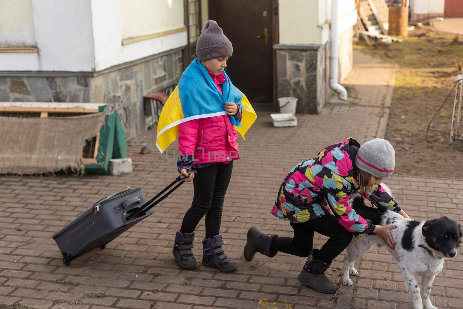 Ukraine military migration. two little girls with a suitcase. Flag of Ukraine, help. Crisis, military conflict by Andelov13