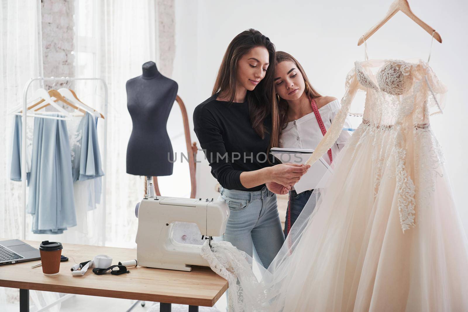 Looks cool. The process of fitting the dress in the studio of hand crafted clothes.