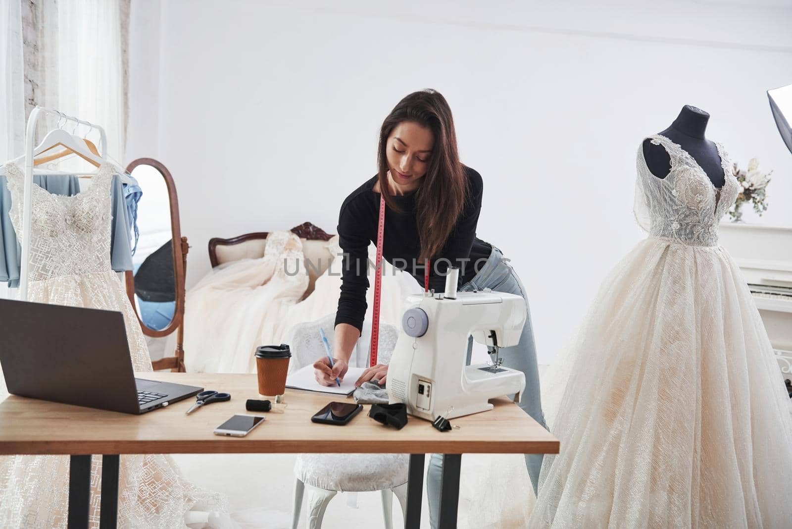 Modern room. Female fashion designer works on the new clothes in the workshop.
