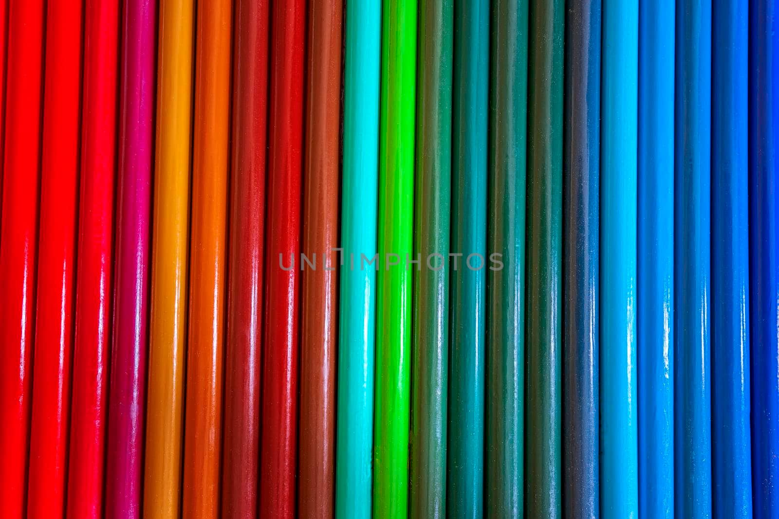 Set of colored pencils in a row. Multicolor background by EdVal