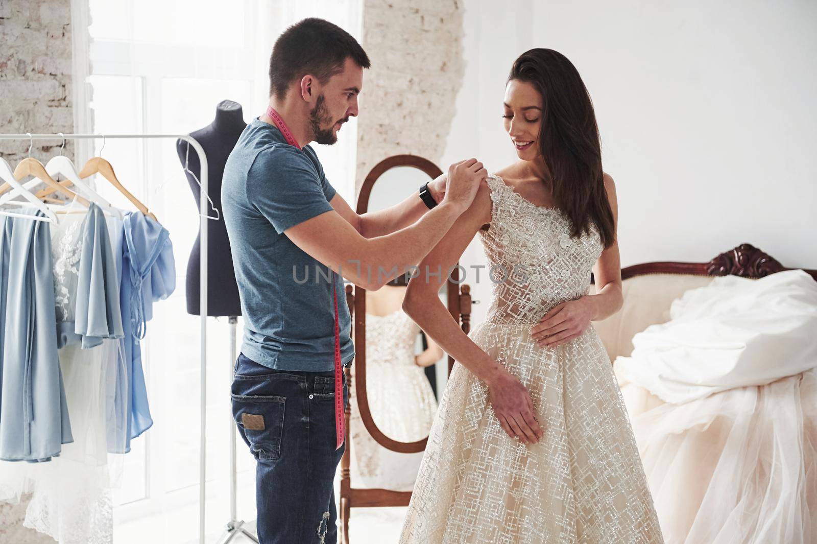 Work in progress. The process of fitting the dress in the studio of hand crafted clothes.