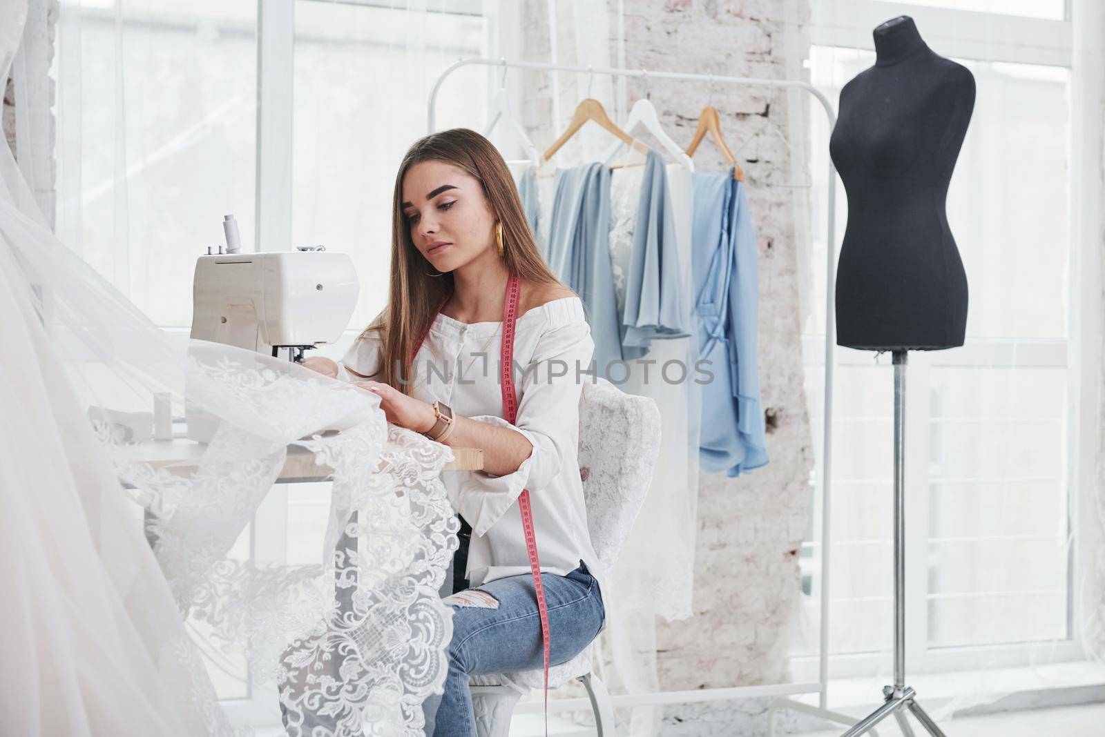 The process of sewing the dress. Female fashion designer works on the new clothes in the workshop.