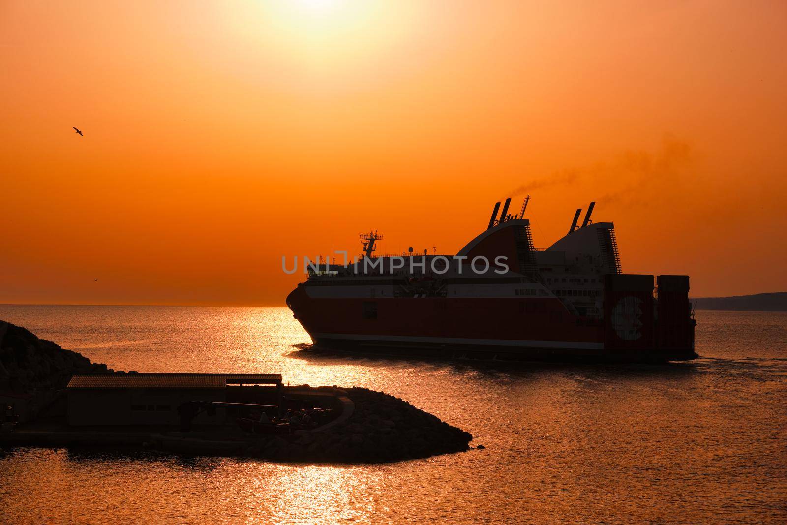 Ferry vessel in sea departing port of Marseille for Corsica on sunset. Marseille, France