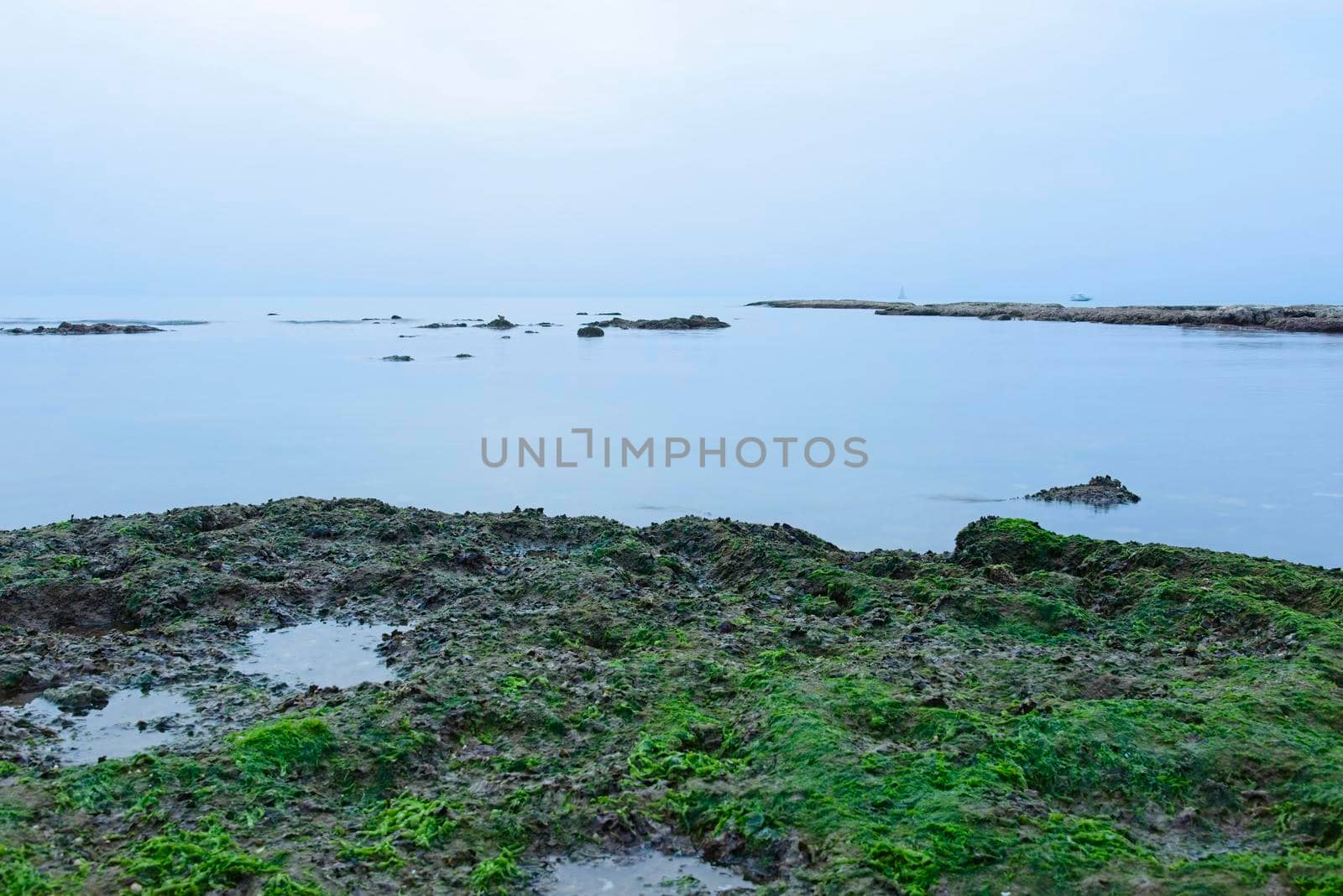 A small fishing boat on the beach in Jaffa, on a foggy day. Concept for peace, quiet and serenity. High key photography. High quality photo