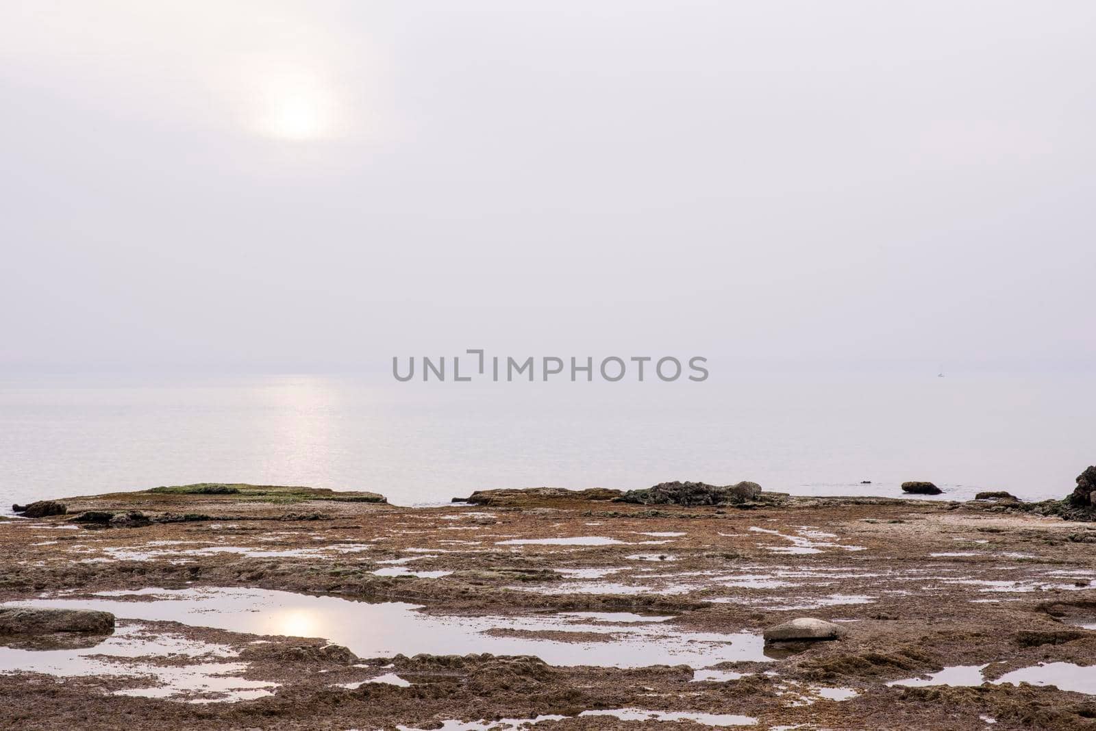 A small fishing boat on the beach in Jaffa, on a foggy day. Concept for peace, quiet and serenity. High key photography. High quality photo