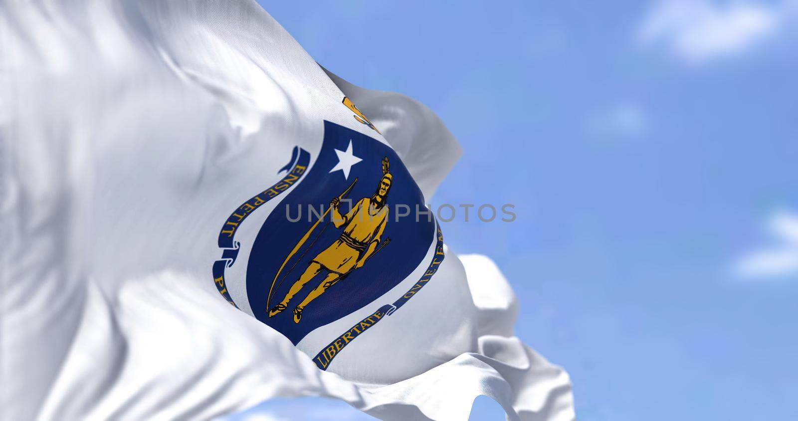 The US state flag of Massachusetts waving in the wind. Massachusetts is the most populous state in the New England region of the United States. Democracy and independence.