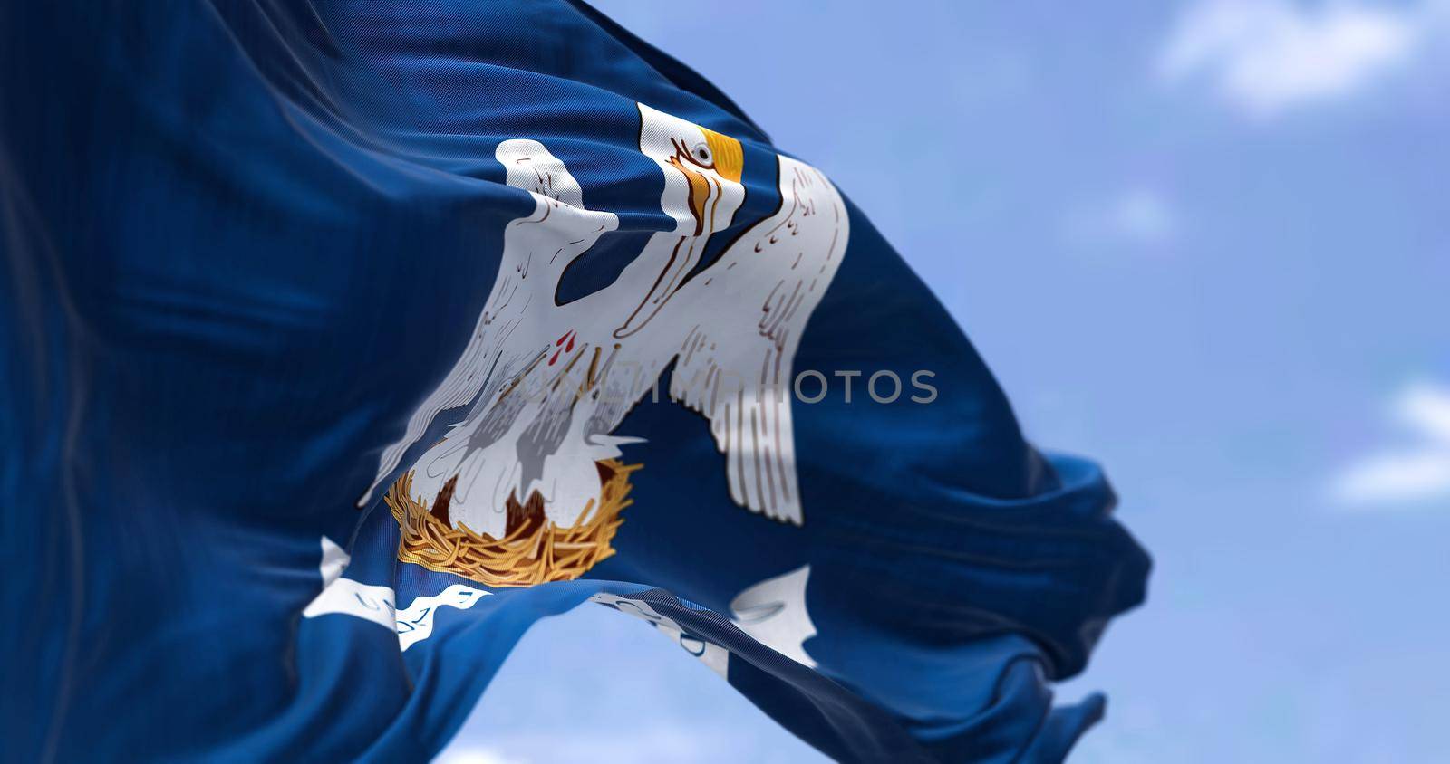 The US state flag of Louisiana waving in the wind. Louisiana is a state in the Deep South and South Central regions of the United States. Democracy and independence.