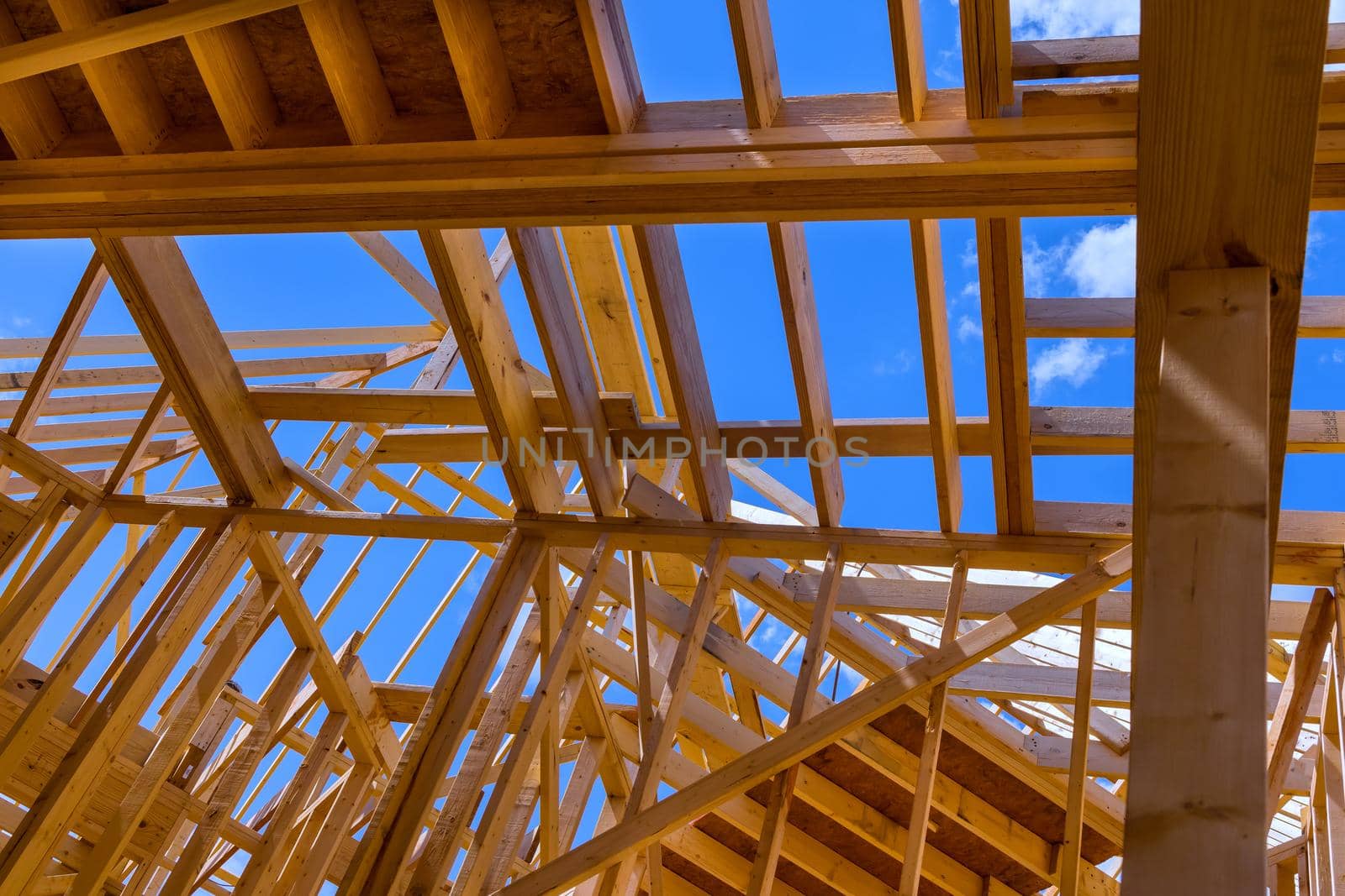 Installation of wooden beams at construction the assembled ceiling and wall on house built frame