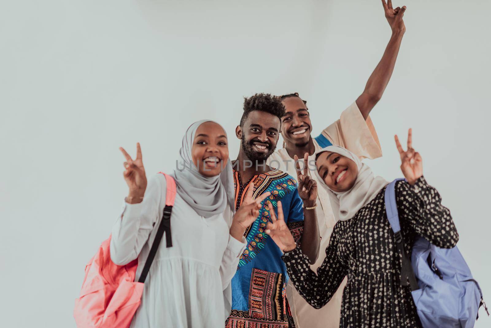 Group of happy african students having conversation and team meeting working together on homework girls wearing traidiional sudan muslim hijab fashion by dotshock