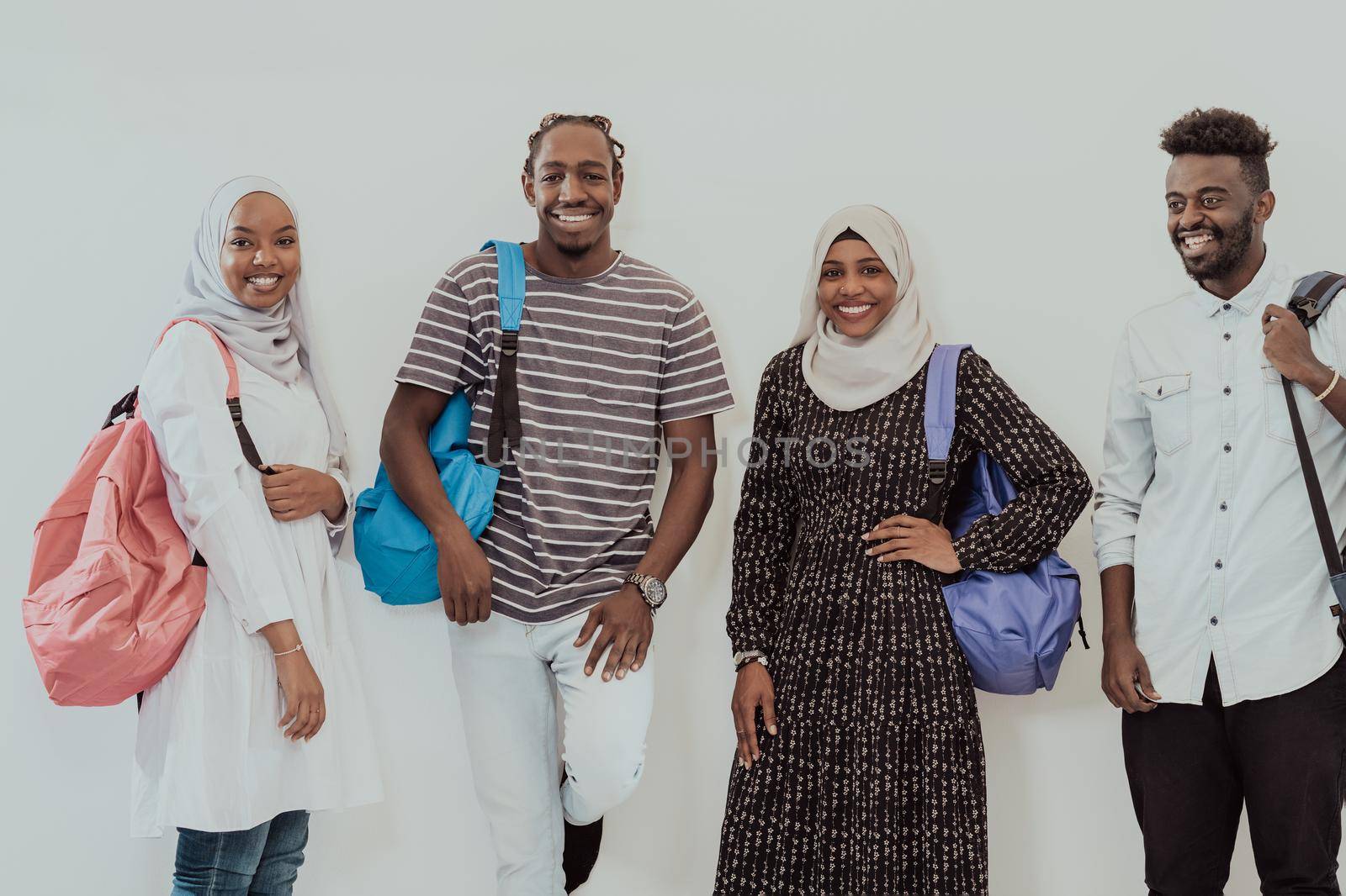 Photo of a group of happy african students talking and meeting together working on homework girls wearing traditional Sudanese Muslim hijab by dotshock